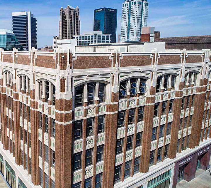 Charming aerial view of a historic building with ornate architecture amidst a vibrant urban skyline.