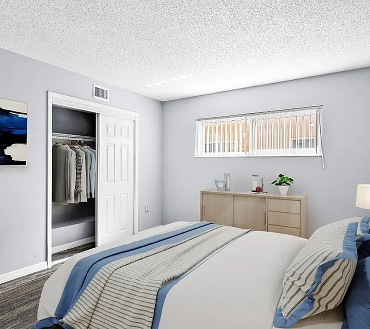 Bright and inviting bedroom featuring modern decor, ample natural light, and a spacious built-in closet.