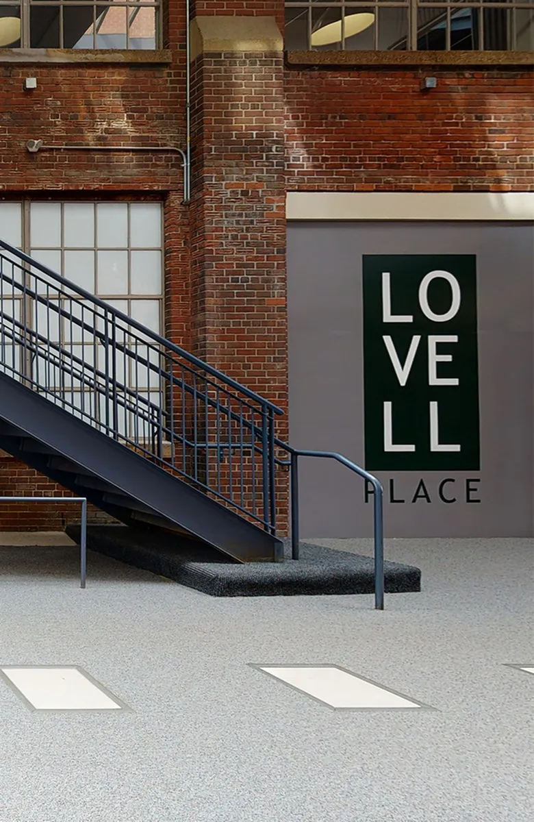 Chic industrial-style interior with exposed brick walls and modern staircase at Lovell Place.