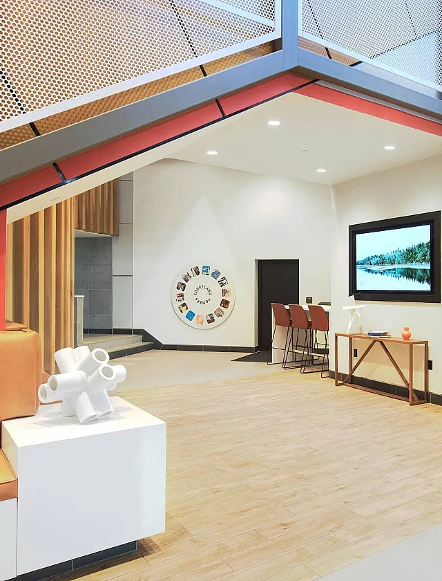 Modern lobby boasting sleek architecture, warm seating area, and contemporary artwork, exuding a stylish ambiance.
