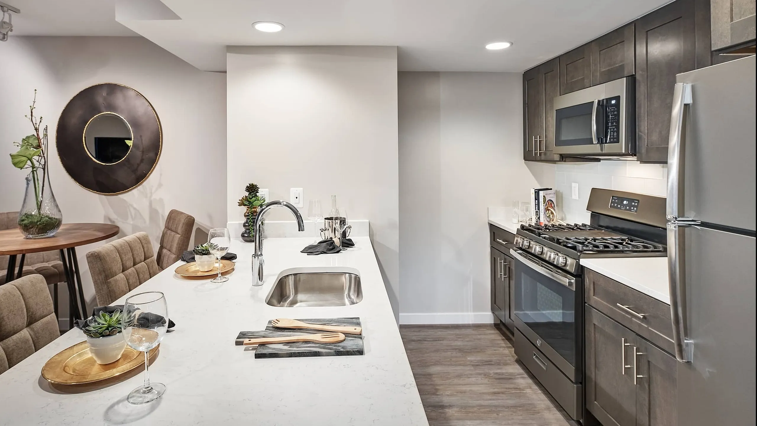 Elegant kitchen with modern appliances, sleek countertops, and a cozy dining area, perfect for entertaining.