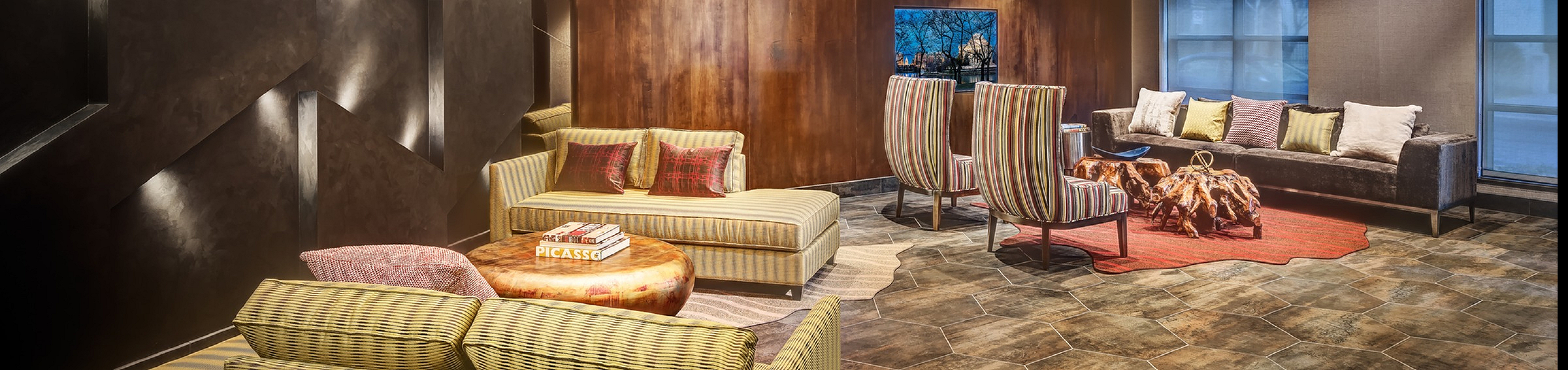 Sophisticated apartment living room featuring modern decor, plush seating, and ambient lighting, perfect for relaxation.