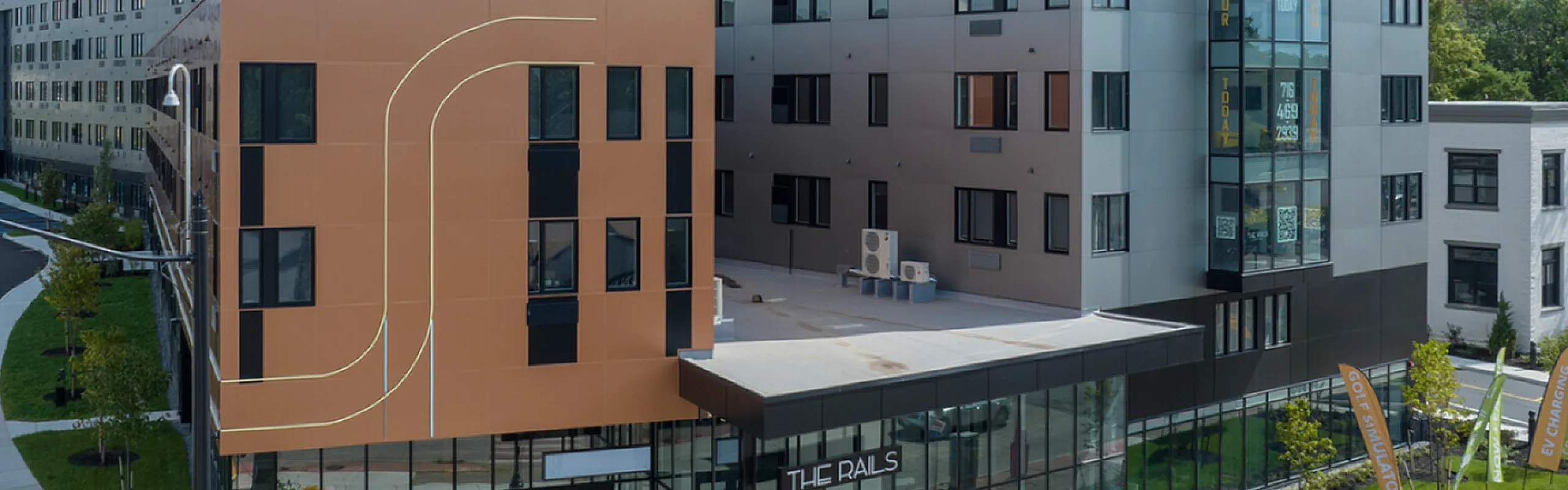 Exterior view of The Rails building featuring windows and LED rail lights.