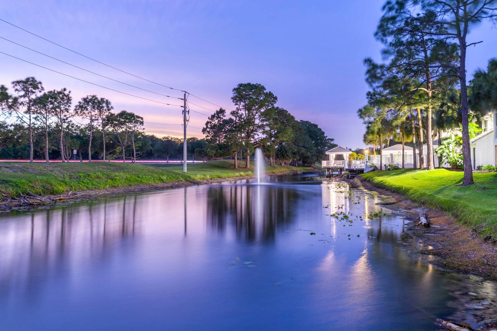 exterior lake with fountain and apartment building