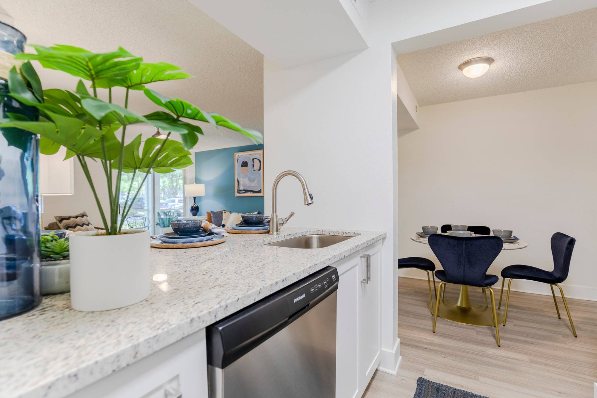 sarasota fl apartments - Tradition at Palm Aire - Kitchen with High-End Appliances, Wood-Style Flooring, and White Cabinetry