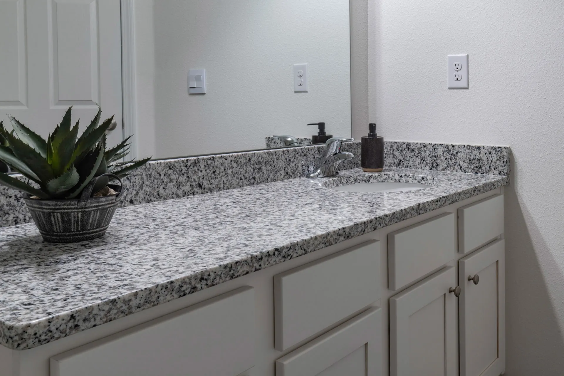 Bathroom with one sink and large mirror