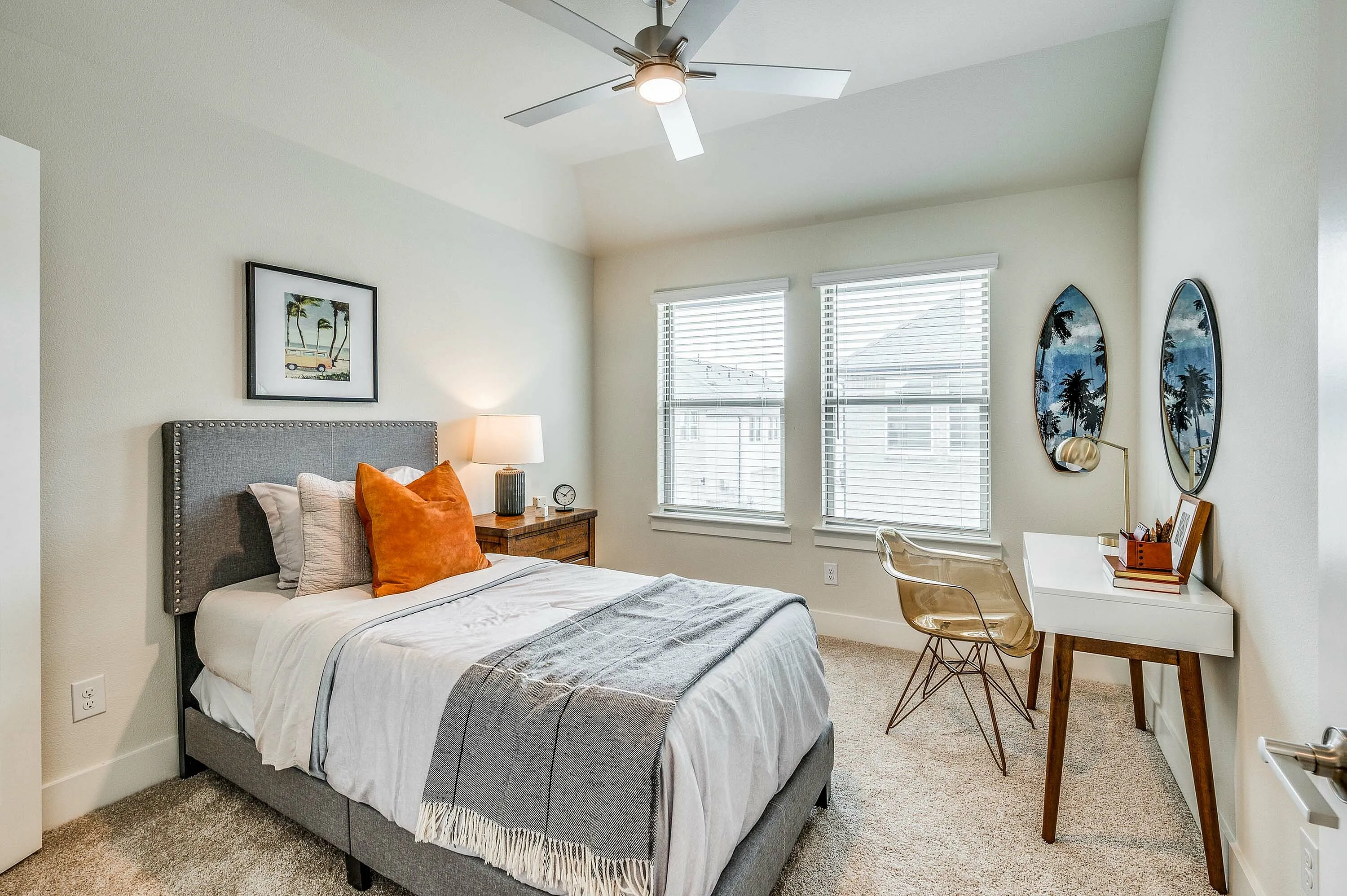 Furnished guest room with bed and desk