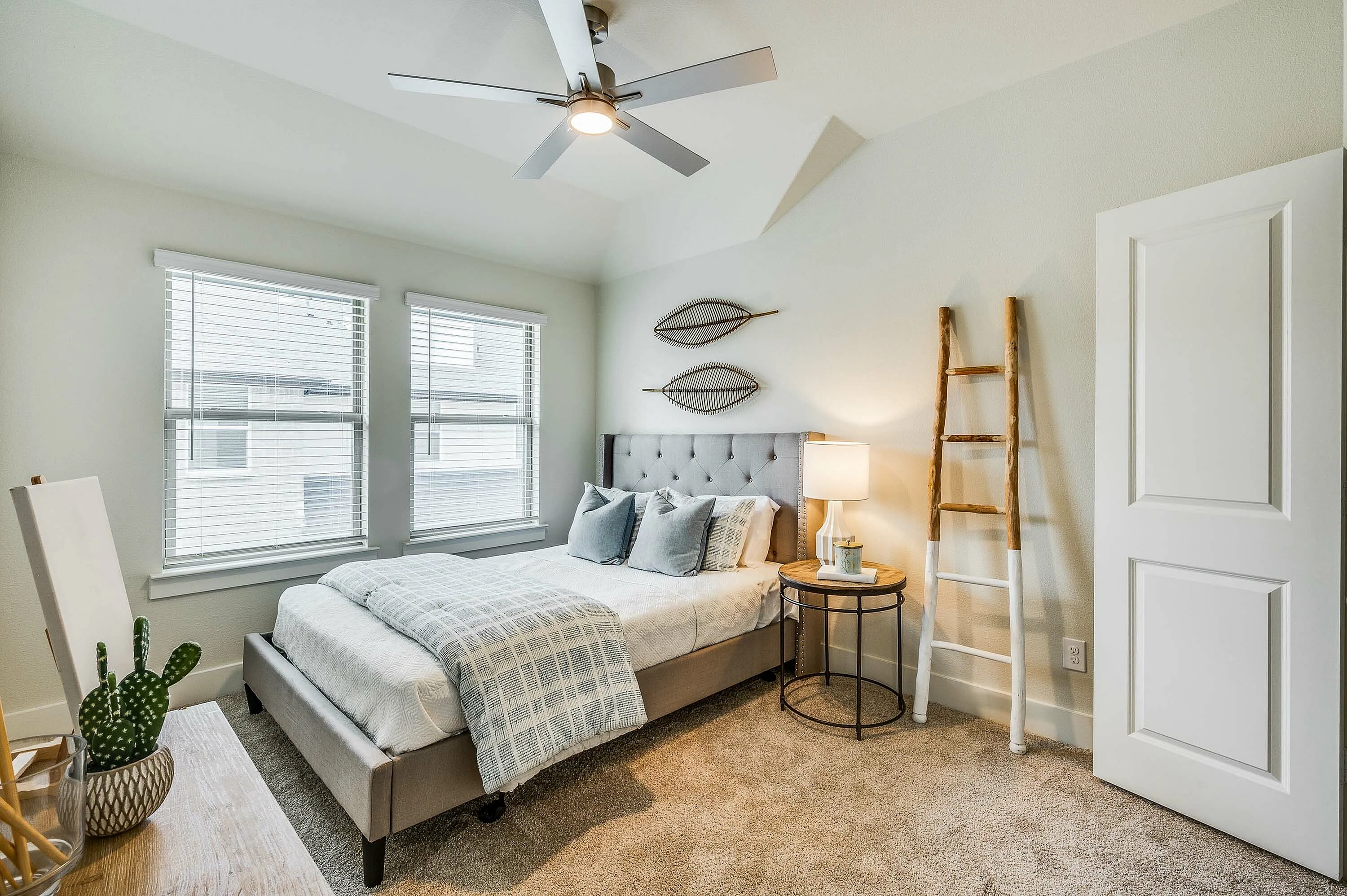 Furnished guest bedroom with bed and dresser