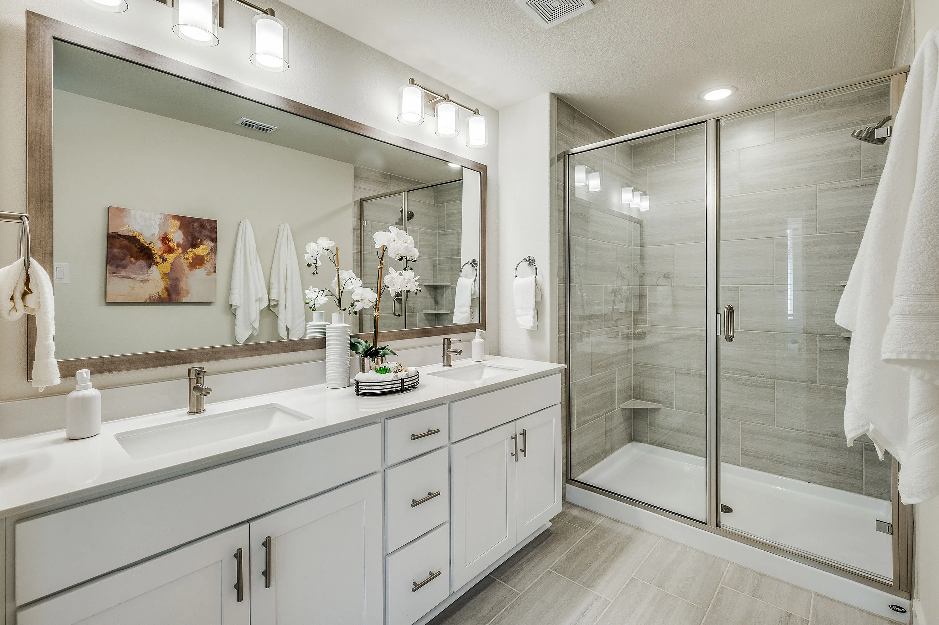 Primary bathroom with double vanity and walk-in closet
