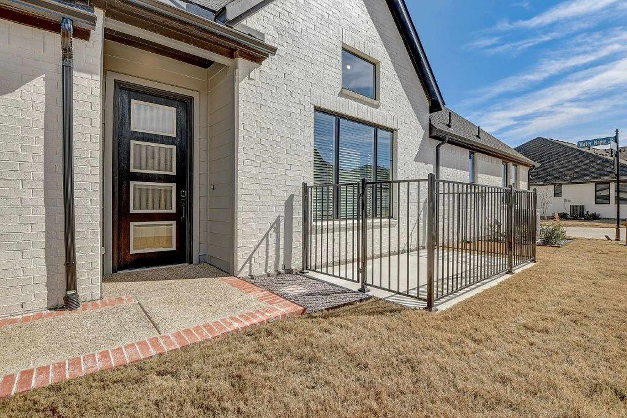 Exterior view of fenced in paved patio outside of a home
