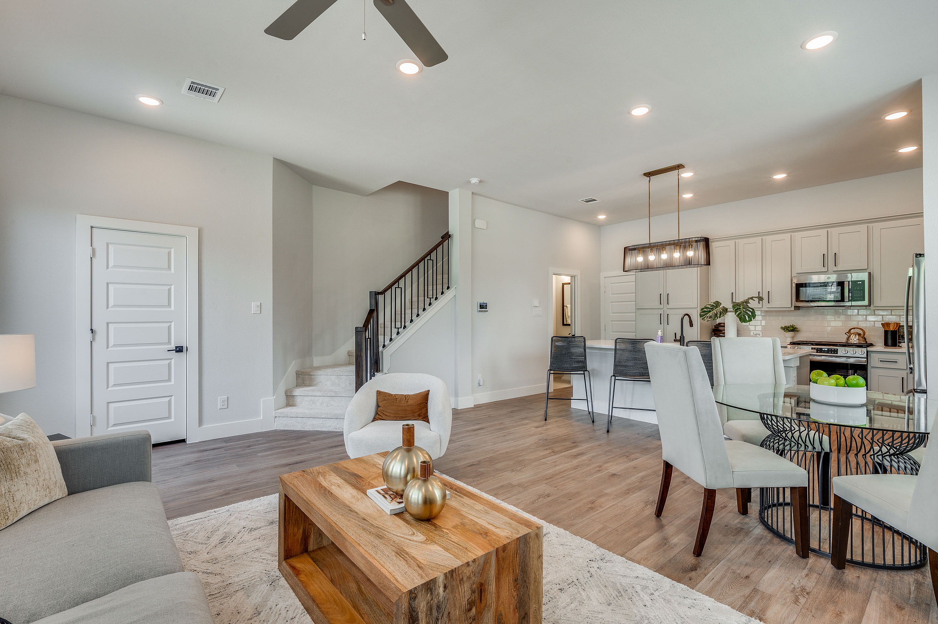 furnished and decorated living room and kitchen with wood style flooring