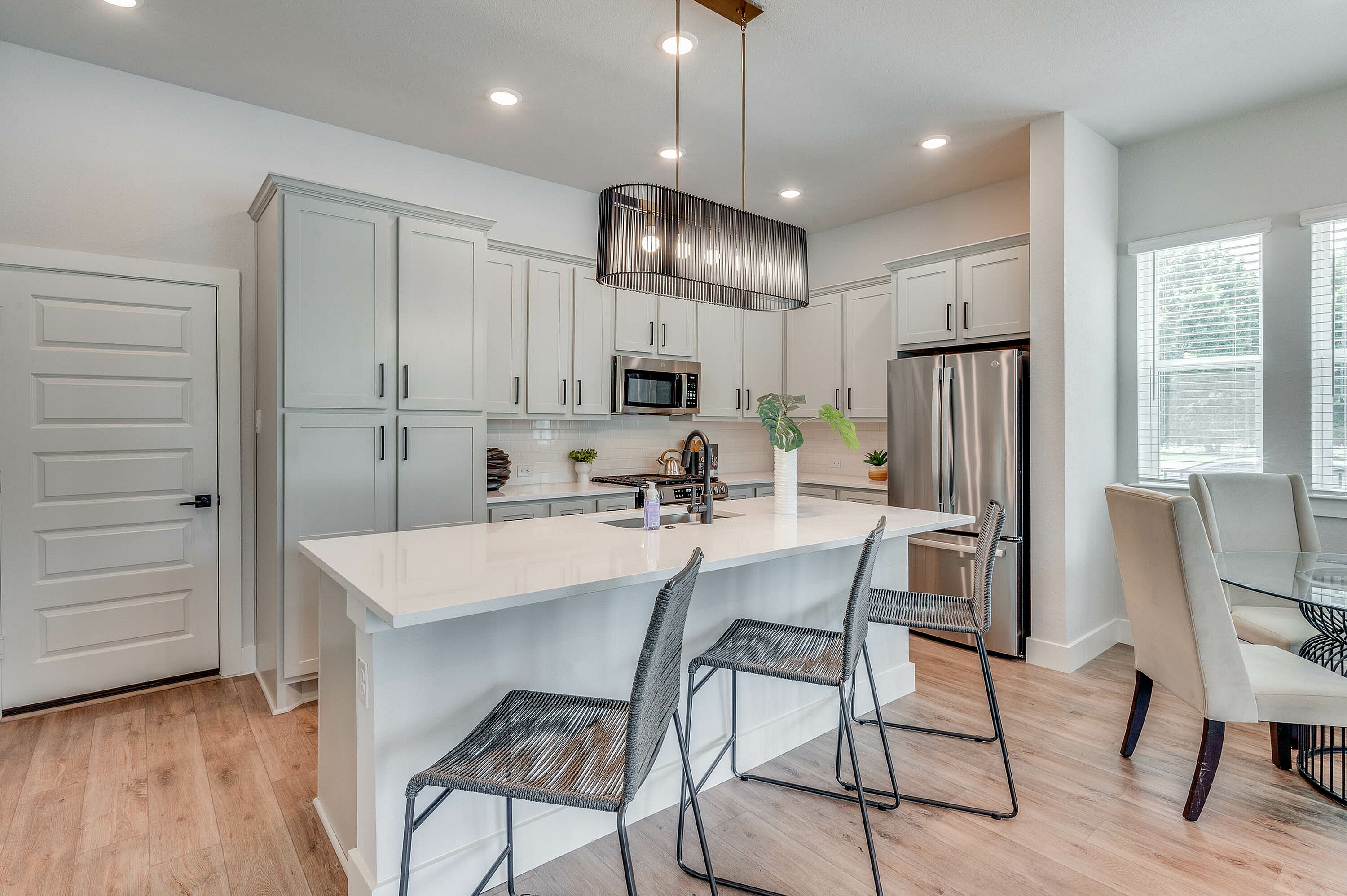 furnished and decorated living room and kitchen with wood style flooring