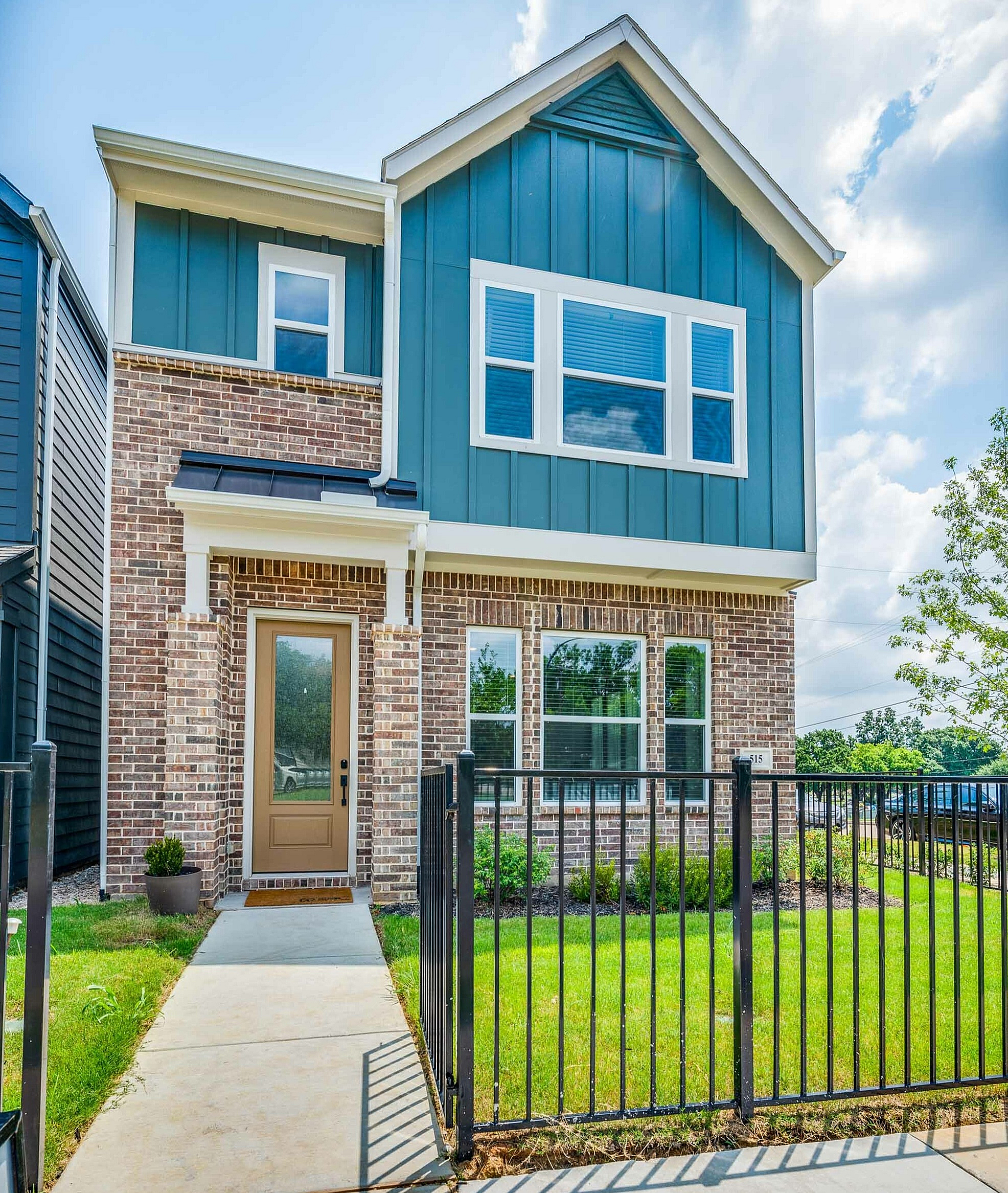 two story home exterior with fenced yard
