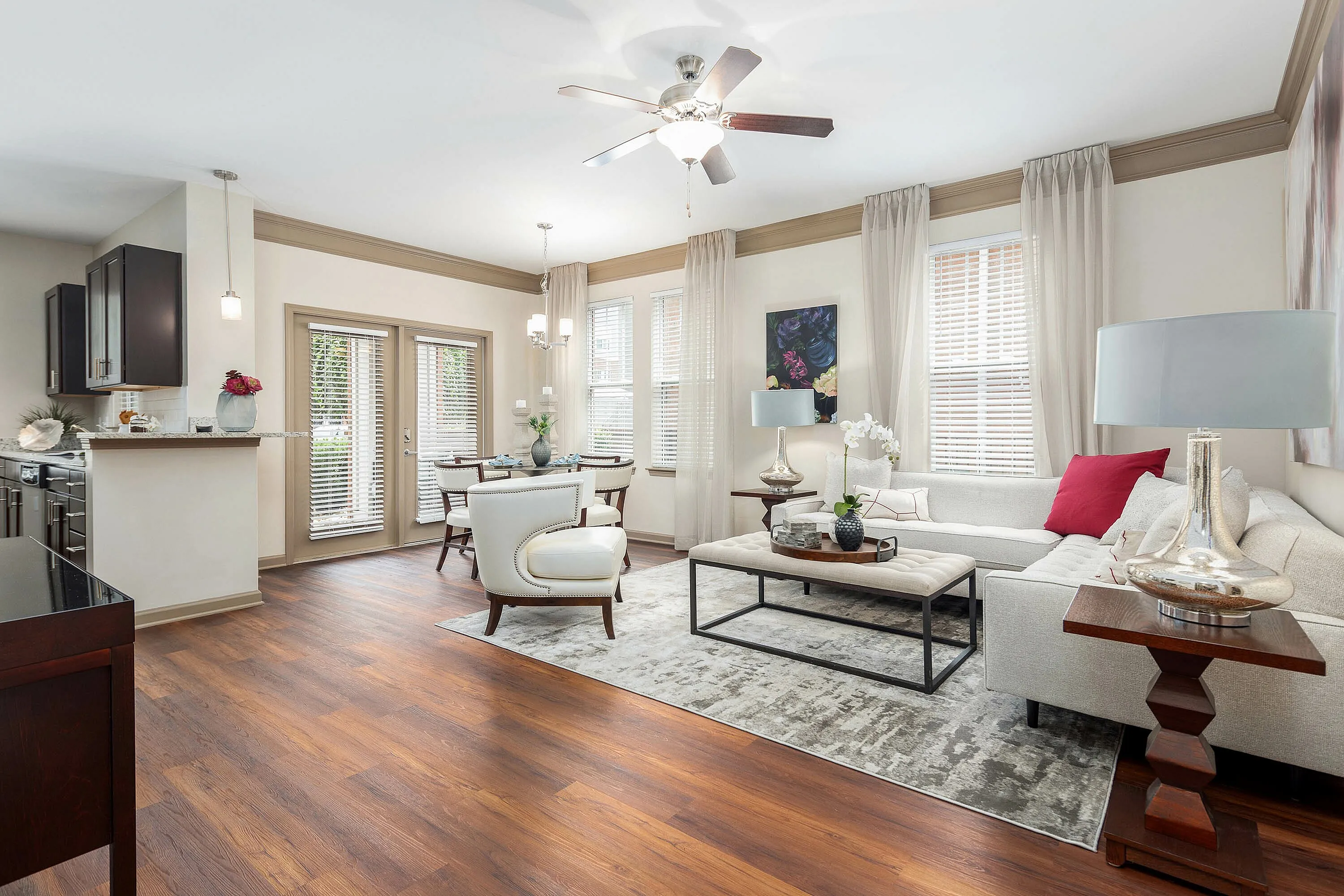 Bright and inviting living room with hardwood floors, modern furniture, and large windows.