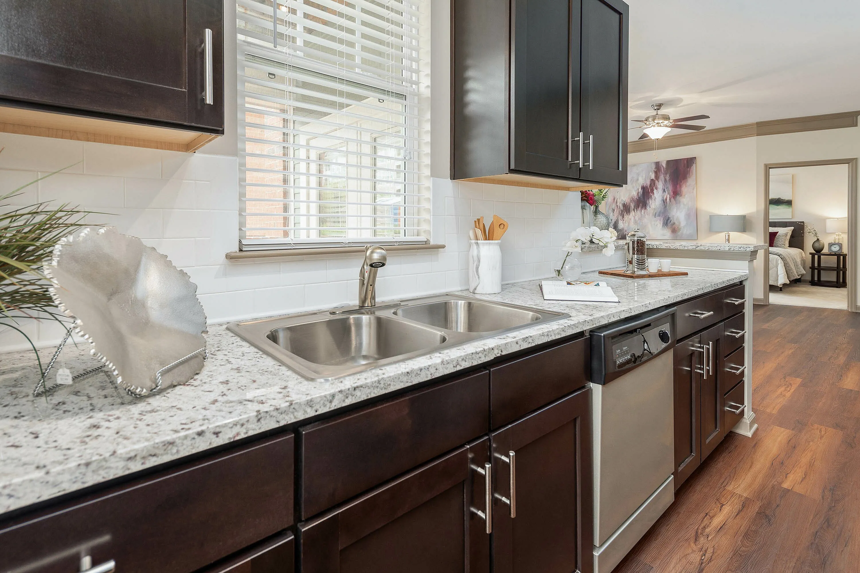 Modern kitchen with granite countertops, stainless steel sink, and elegant cabinetry.