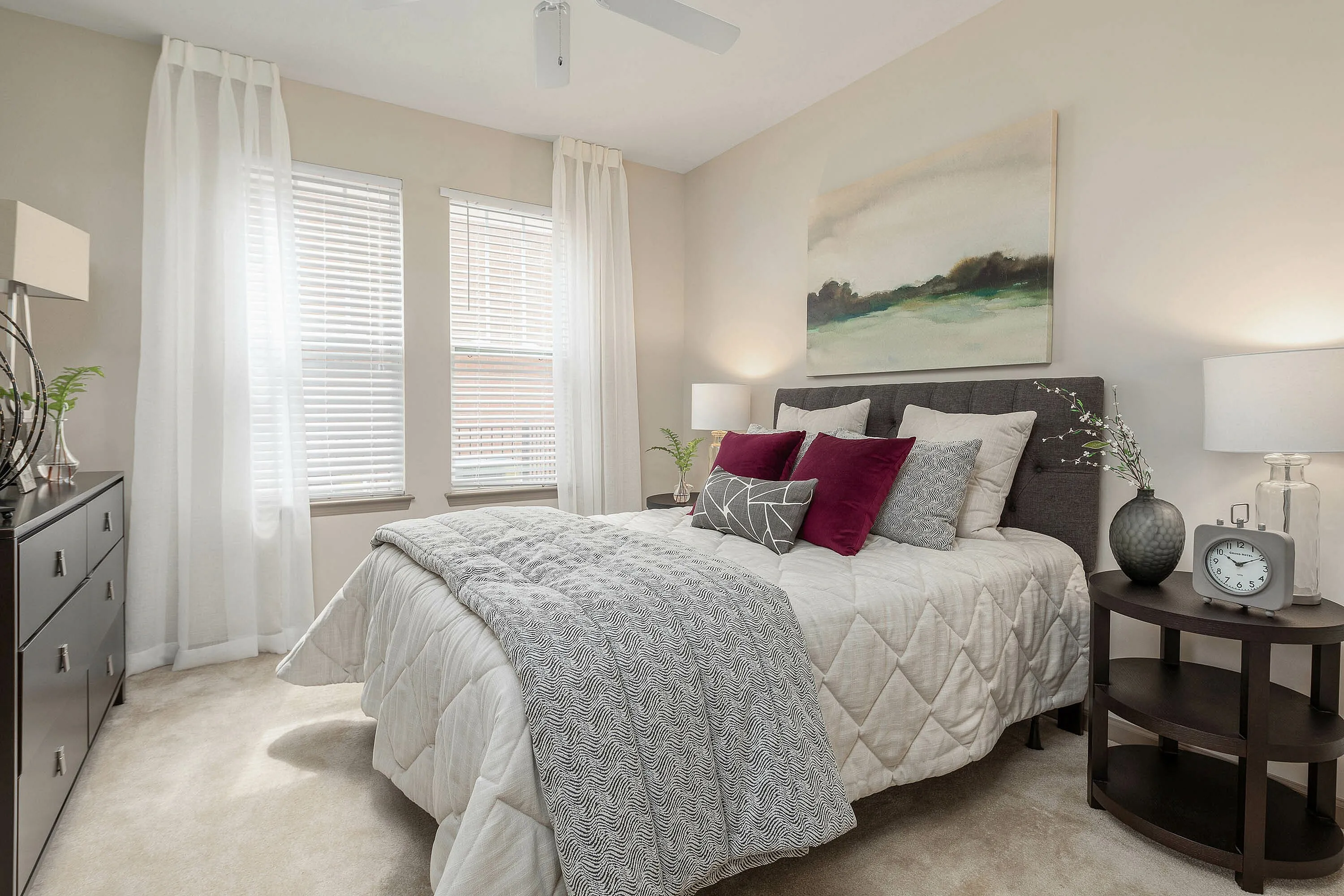 Bright and cozy bedroom with neutral tones, featuring lush bedding and modern decor.
