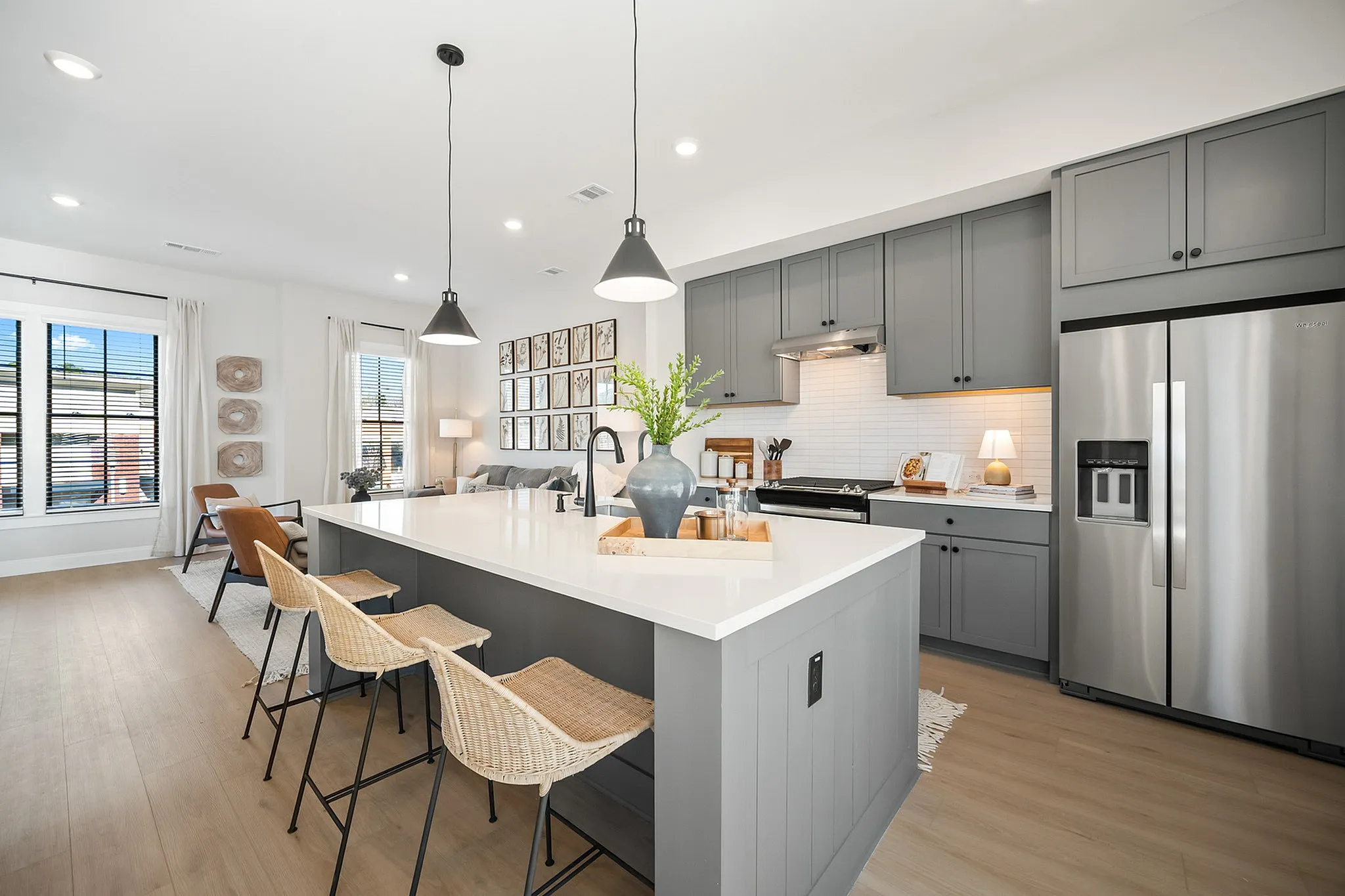 Furnished kitchen with grey cabinets and large island