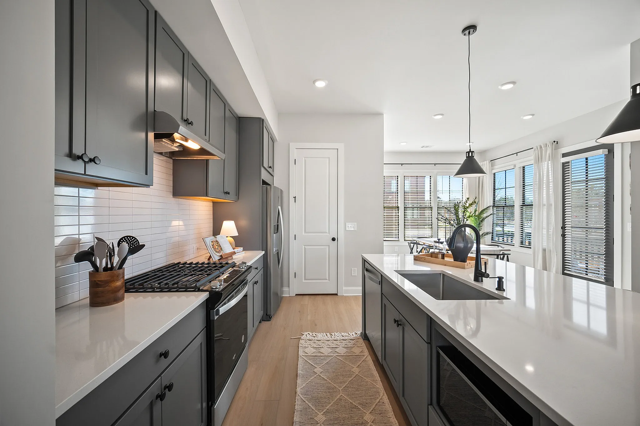 Furnished kitchen with grey cabinets and large island