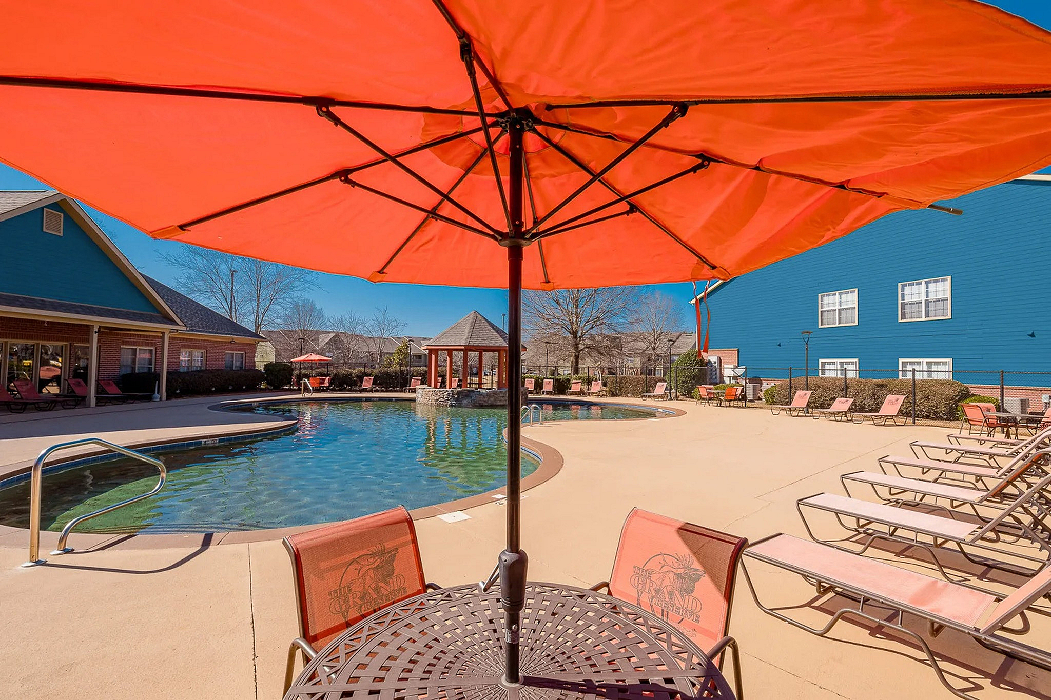 Sparkling swimming pool with chairs and umbrellas