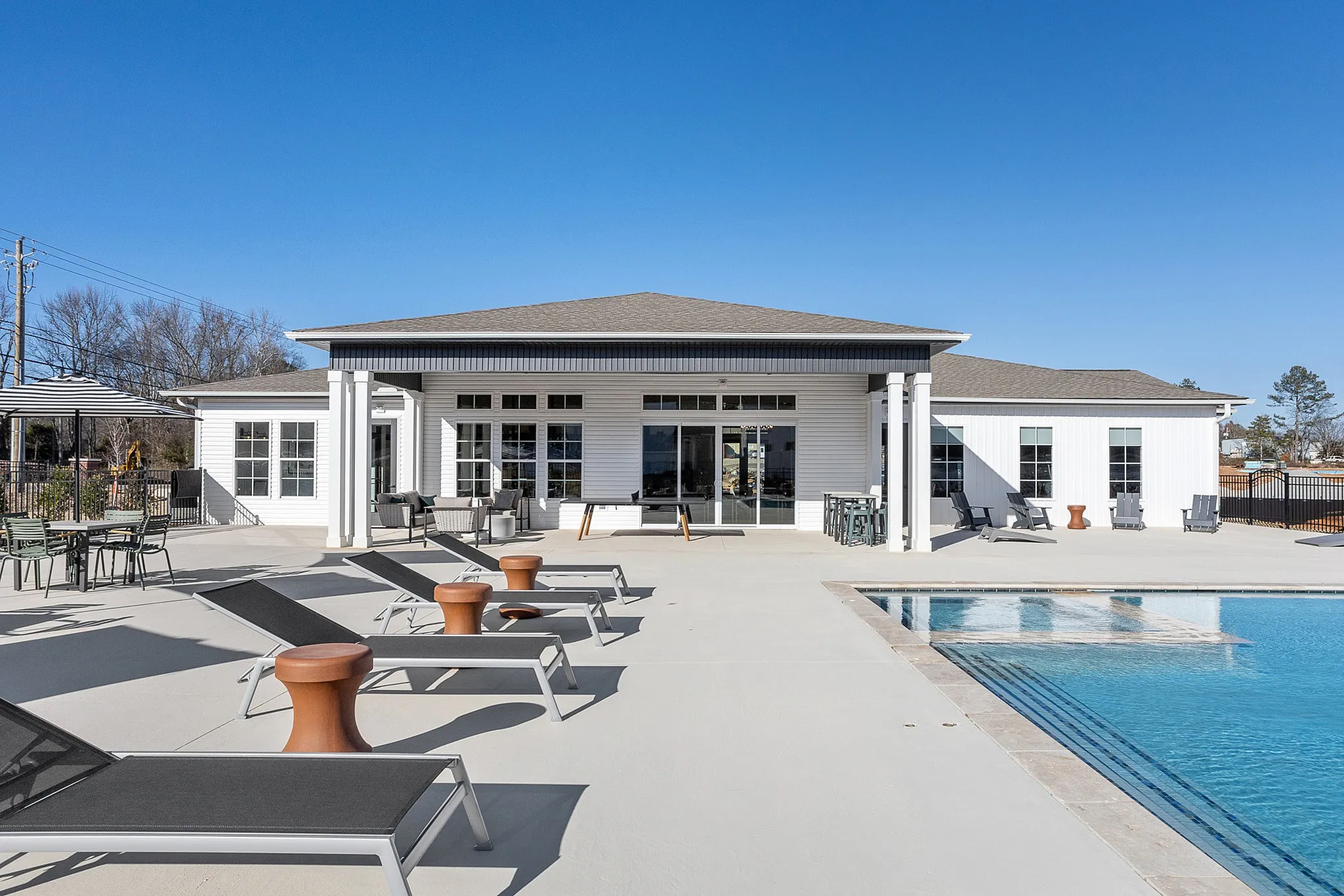 Sparkling swimming pool and lounge chairs