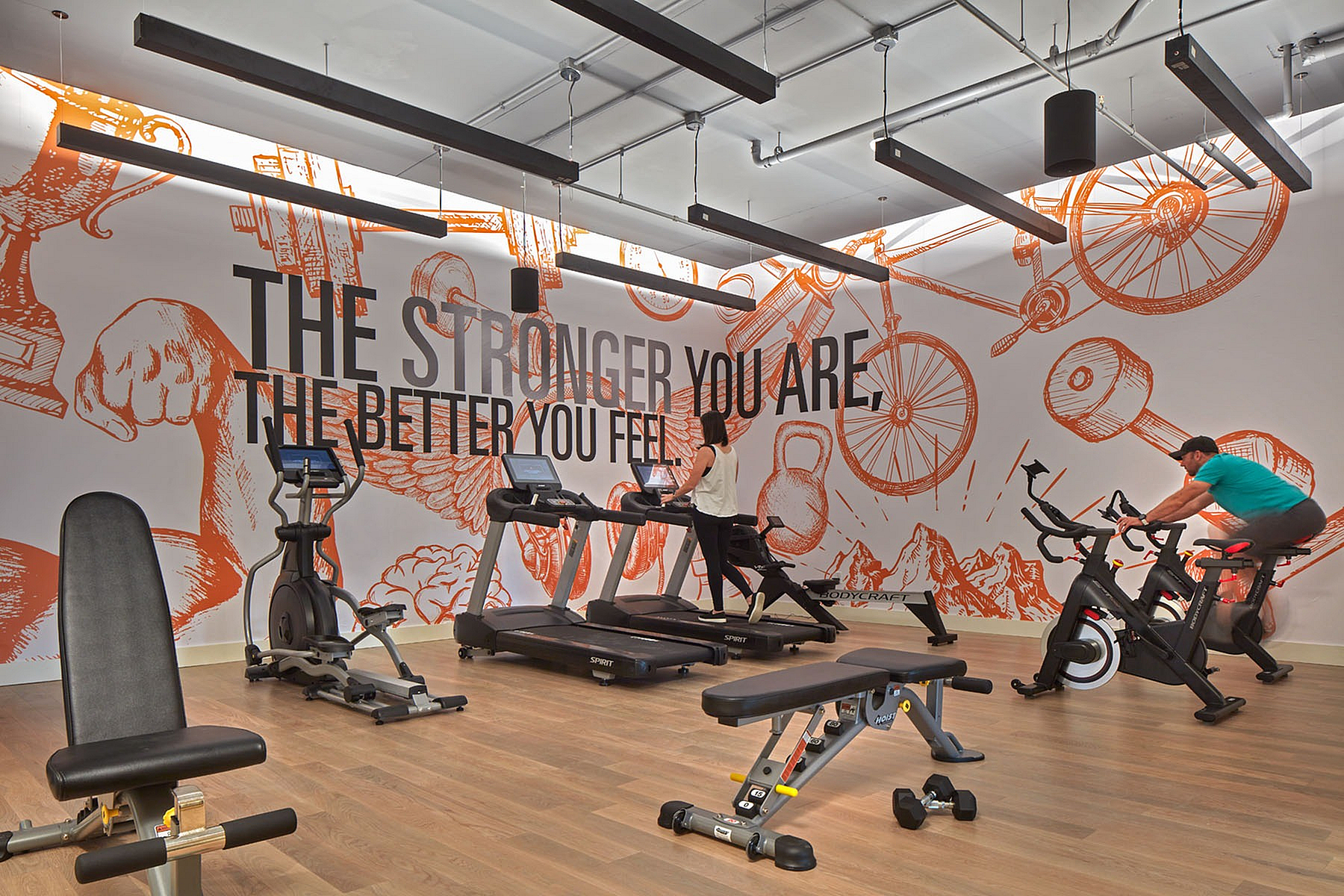 Two-Bedroom Luxury Apartments Viera FL - Luna At Viera - Fitness Center Featuring Cardio Machines And Bold Wall Art