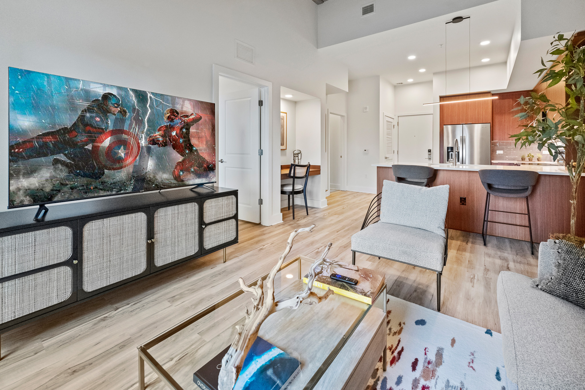 stylish decorated living room and kitchen with custom cabinets
