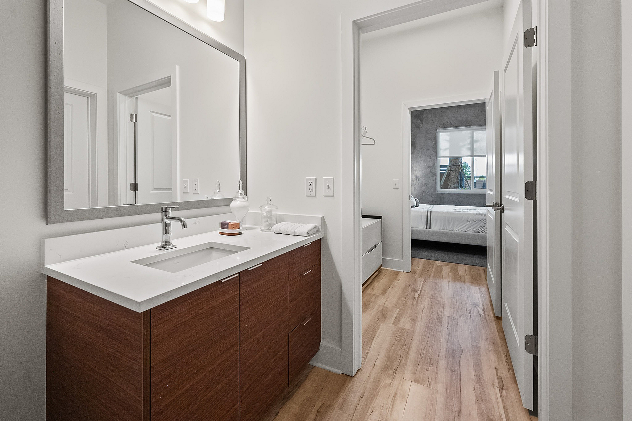Modern and sleek bathroom leading into walk through closet and guest bedroom