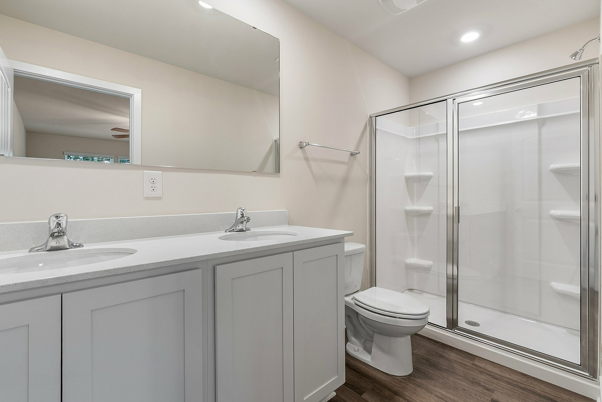 Primary bathroom with double vanity and walk-in shower
