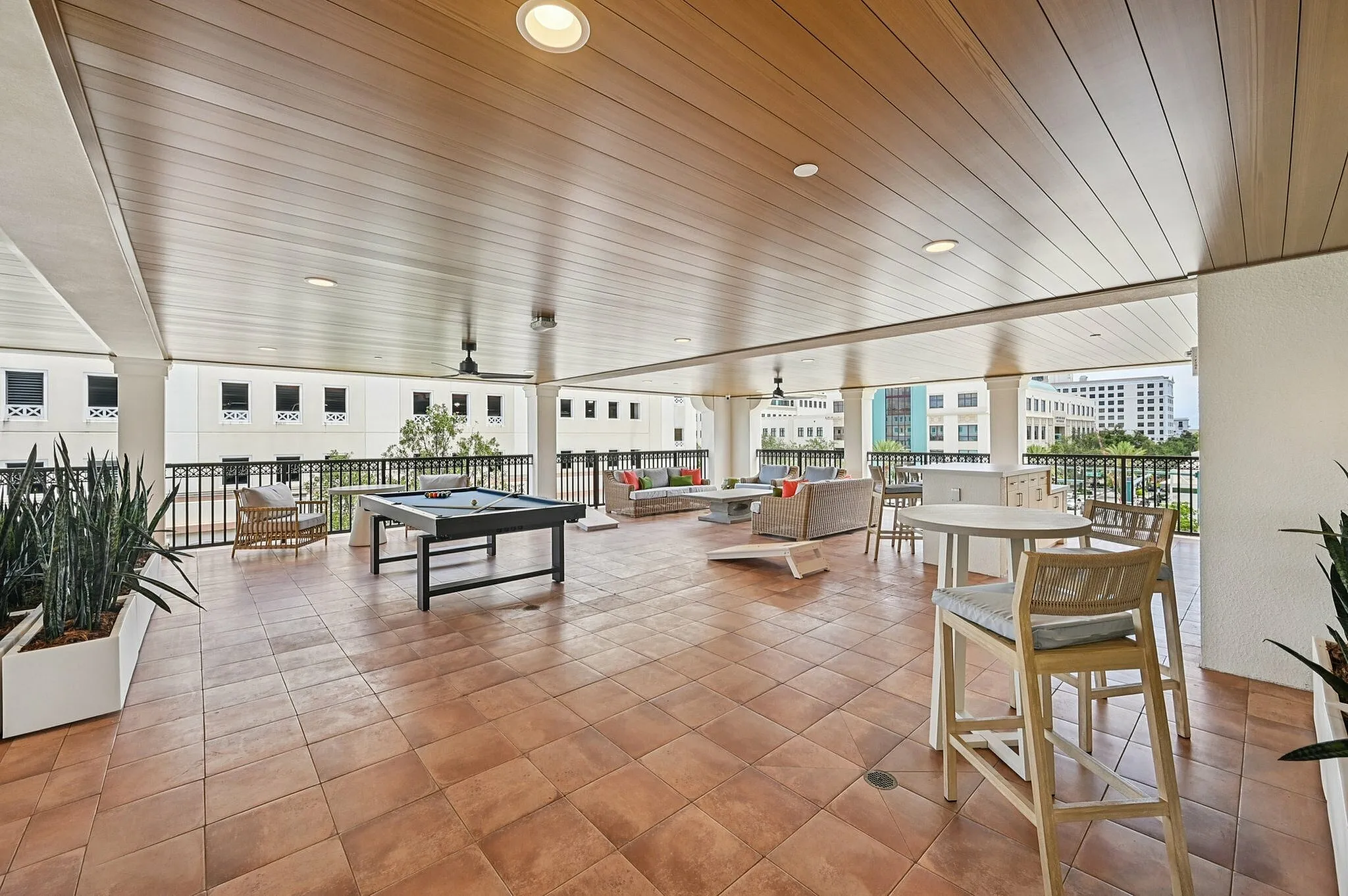 Outdoor clubhouse with pool table and tables and chairs