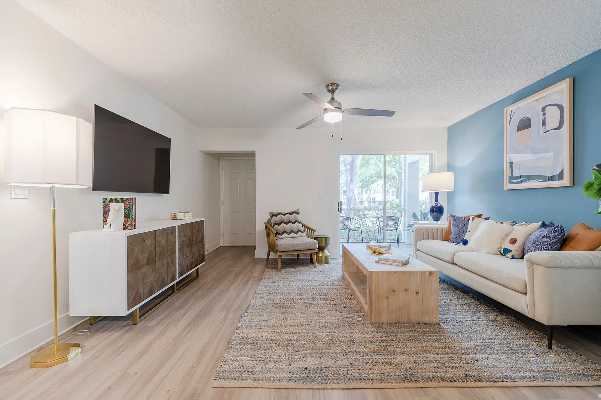Living room with couch, table and exit to balcony