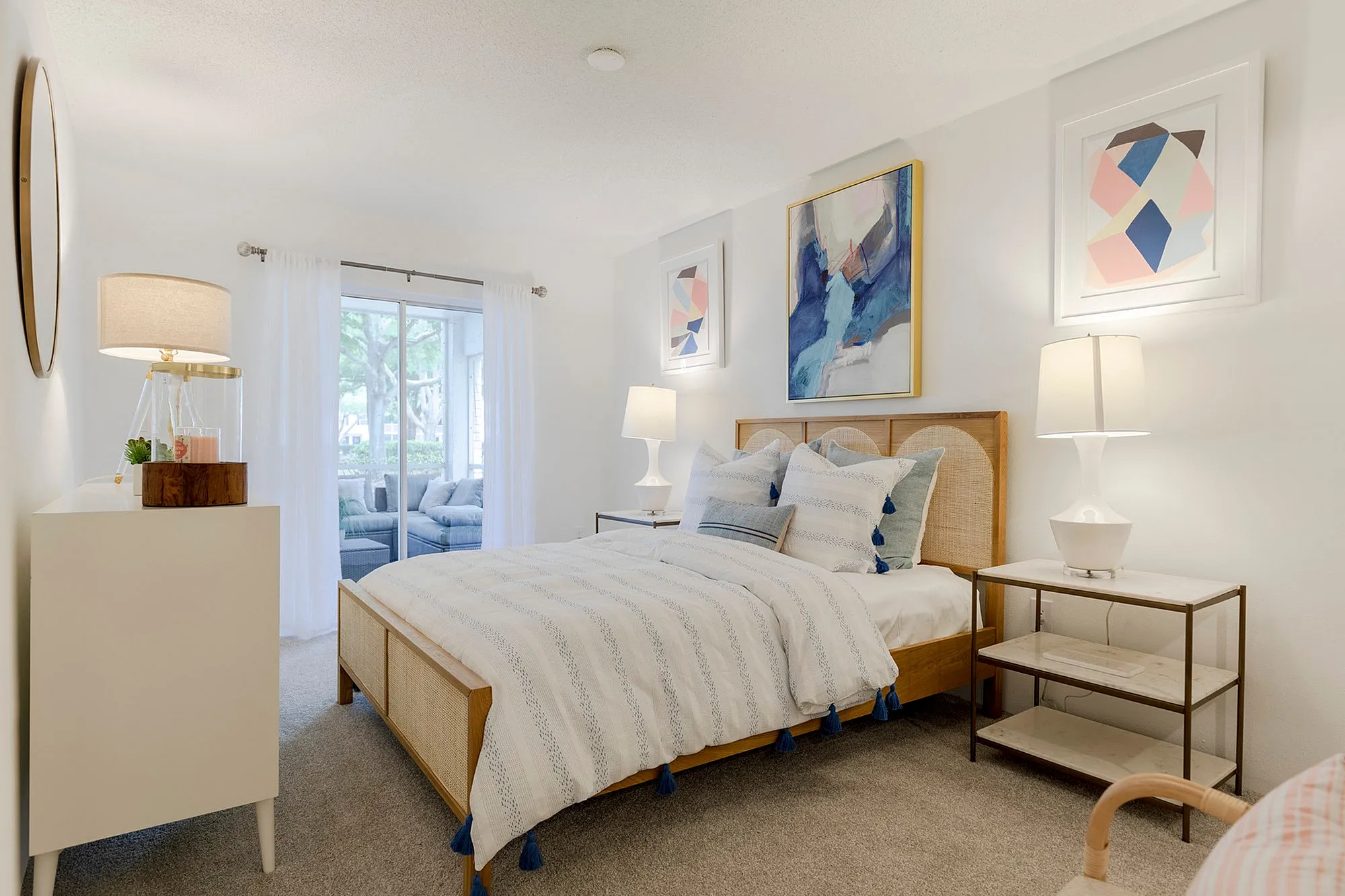 Furnished bedroom with bed and dresser and access to balcony