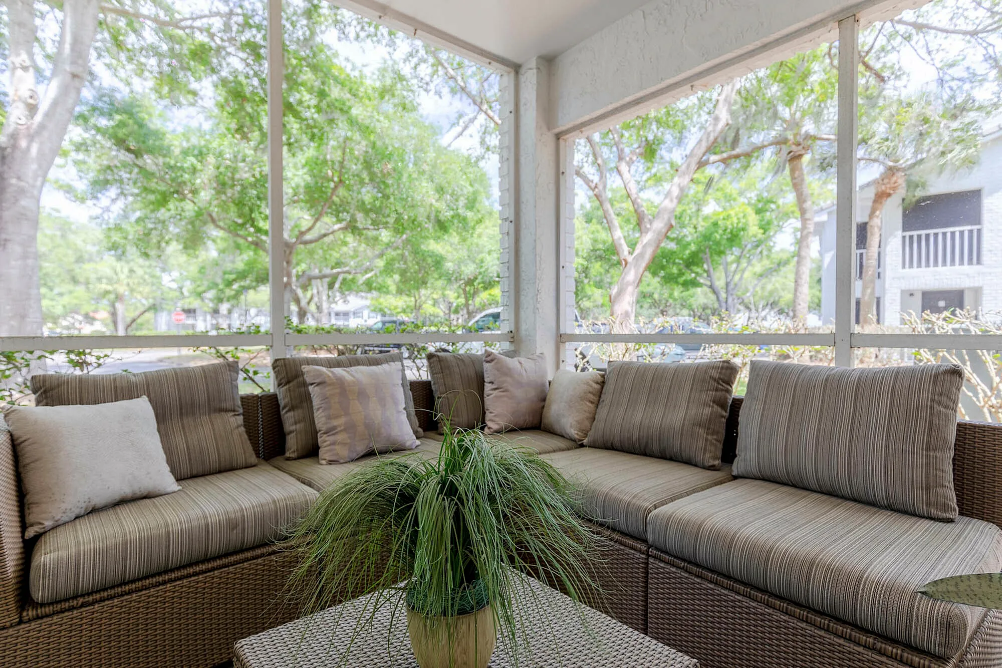 Screened in porch with L shaped couch