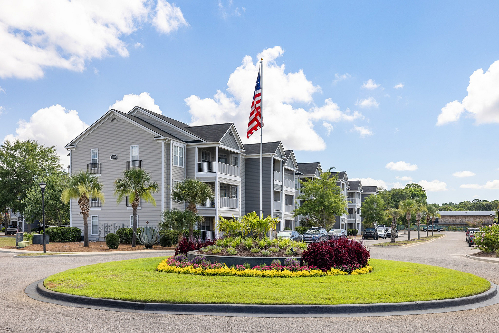 Exterior of community with flag and roundabout