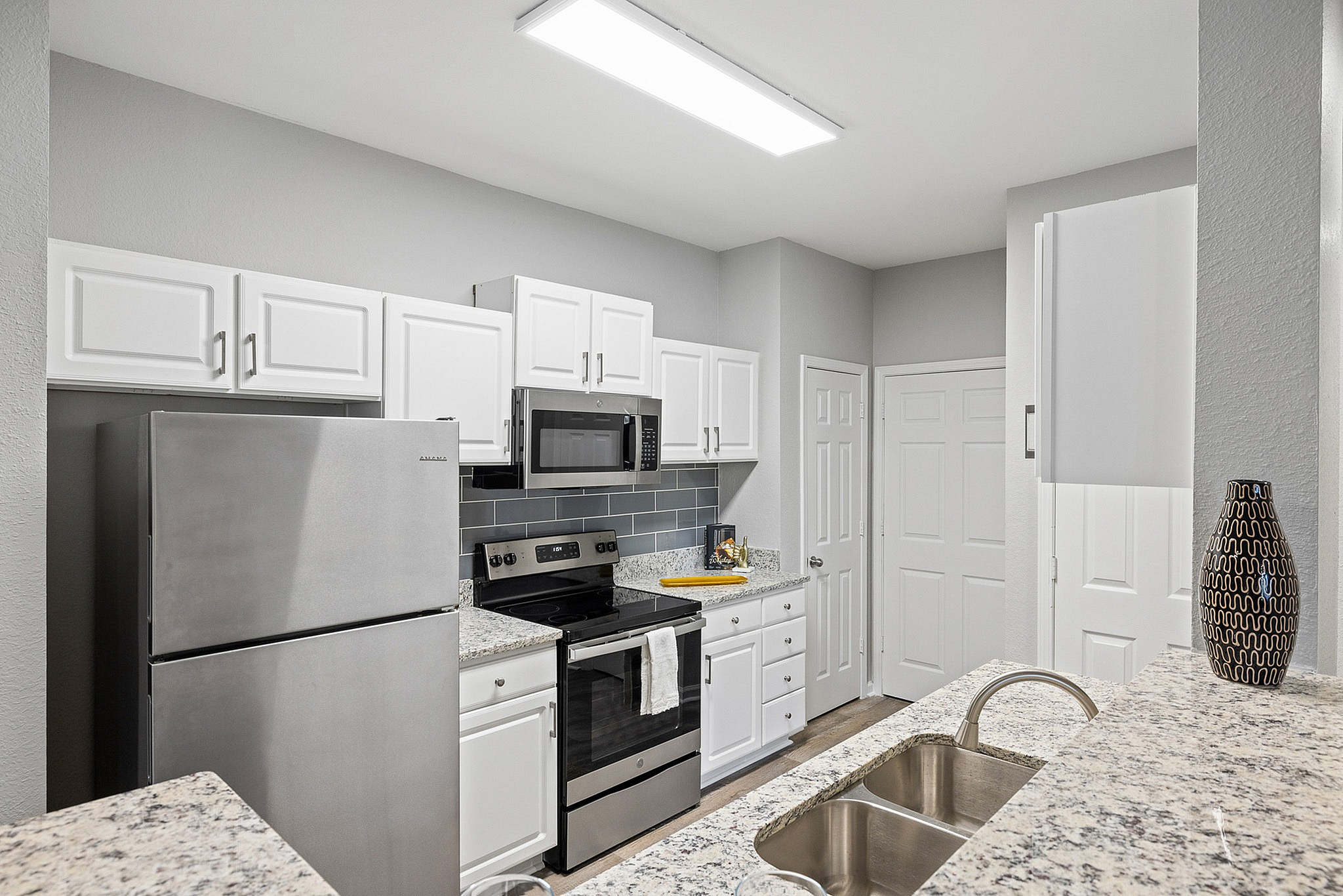 Kitchen with white cabinets and stainless steel appliances