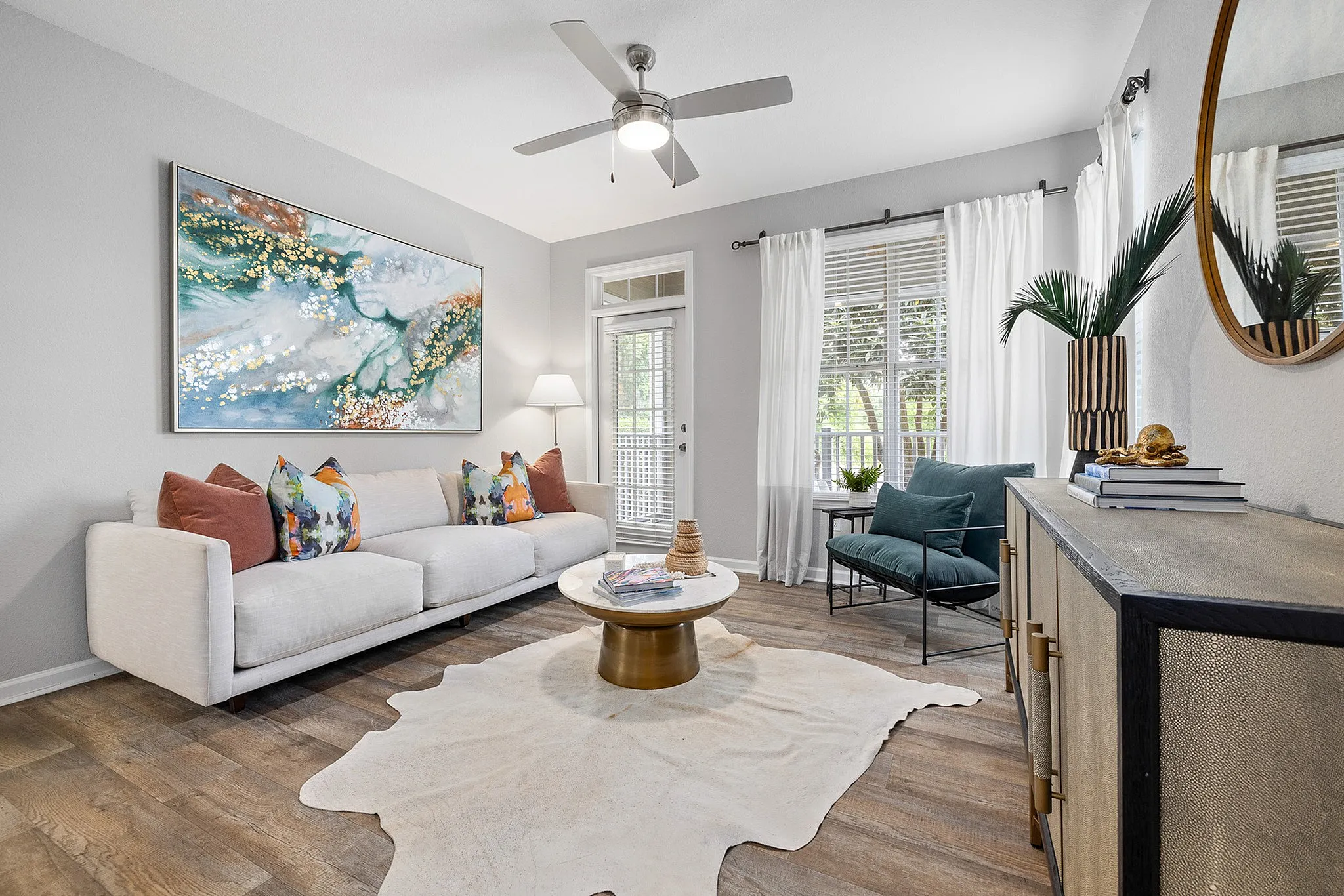 Living room with couch, coffee table and door to attached balcony/patio