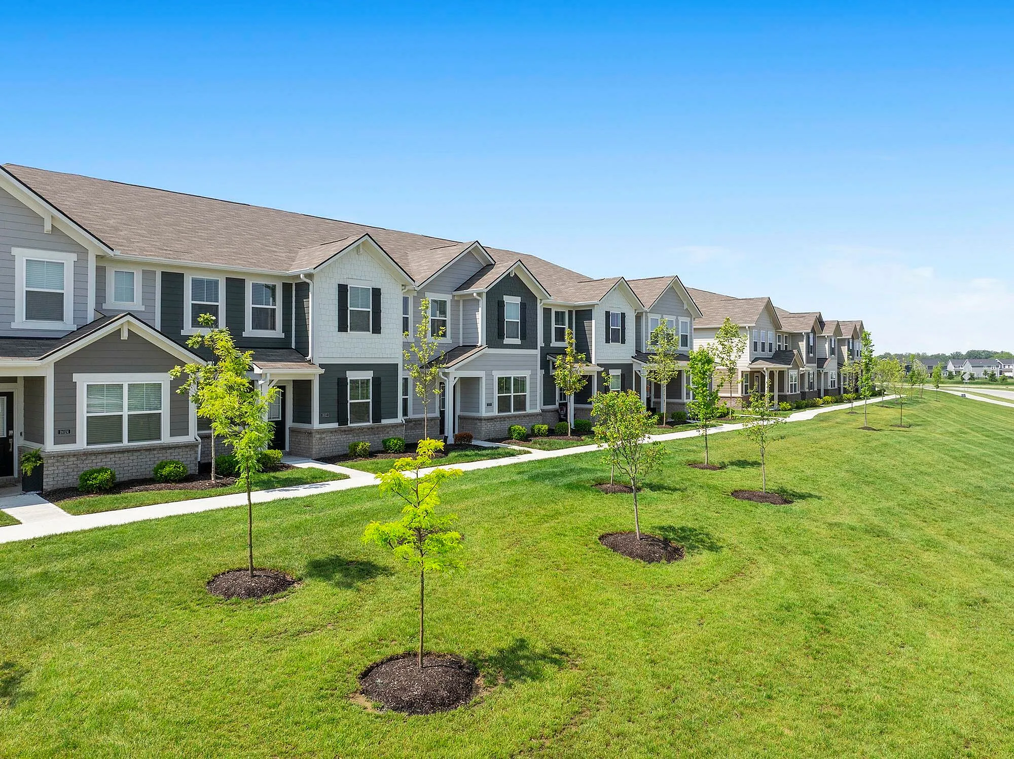 Exterior of homes with trees and green space