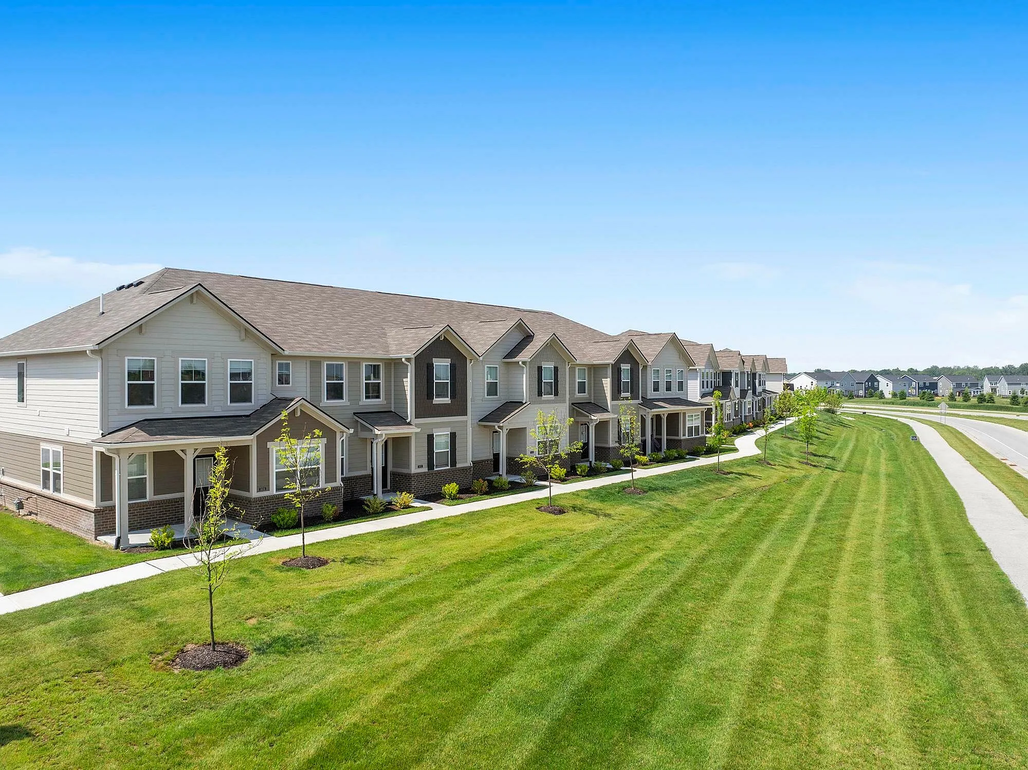 Exterior of homes with trees and green space
