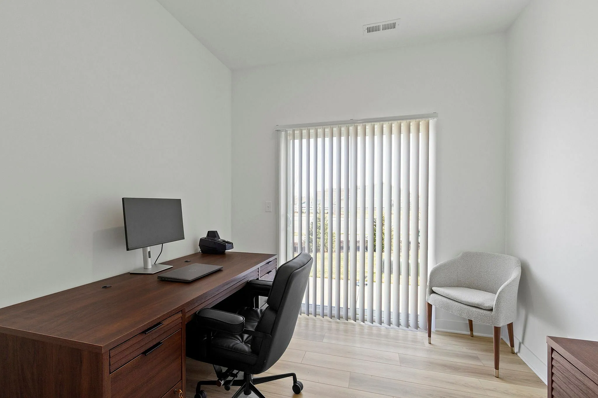 Spare room and office with desk and chairs