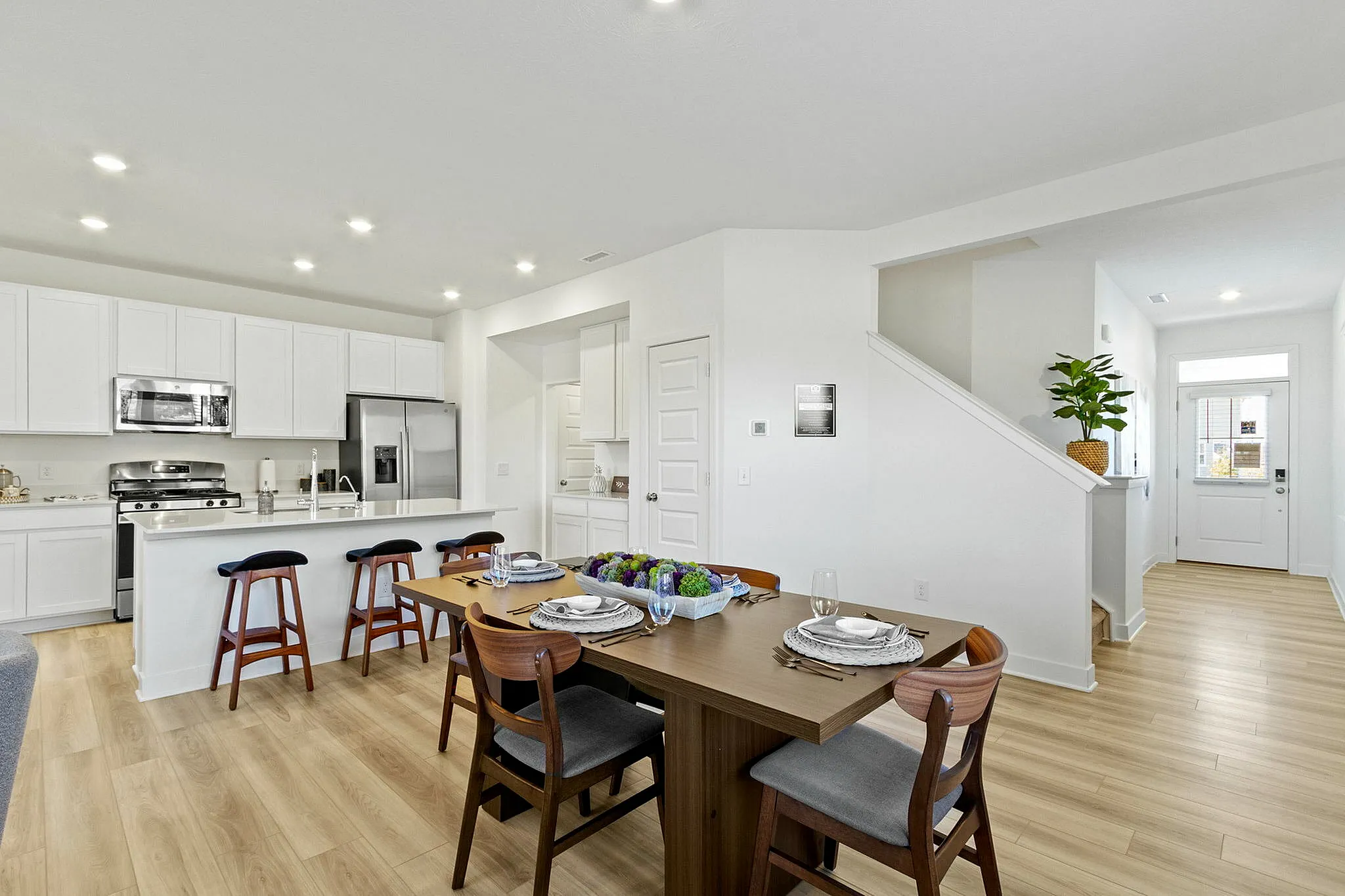 furnished kitchen and dining area with wood style flooring