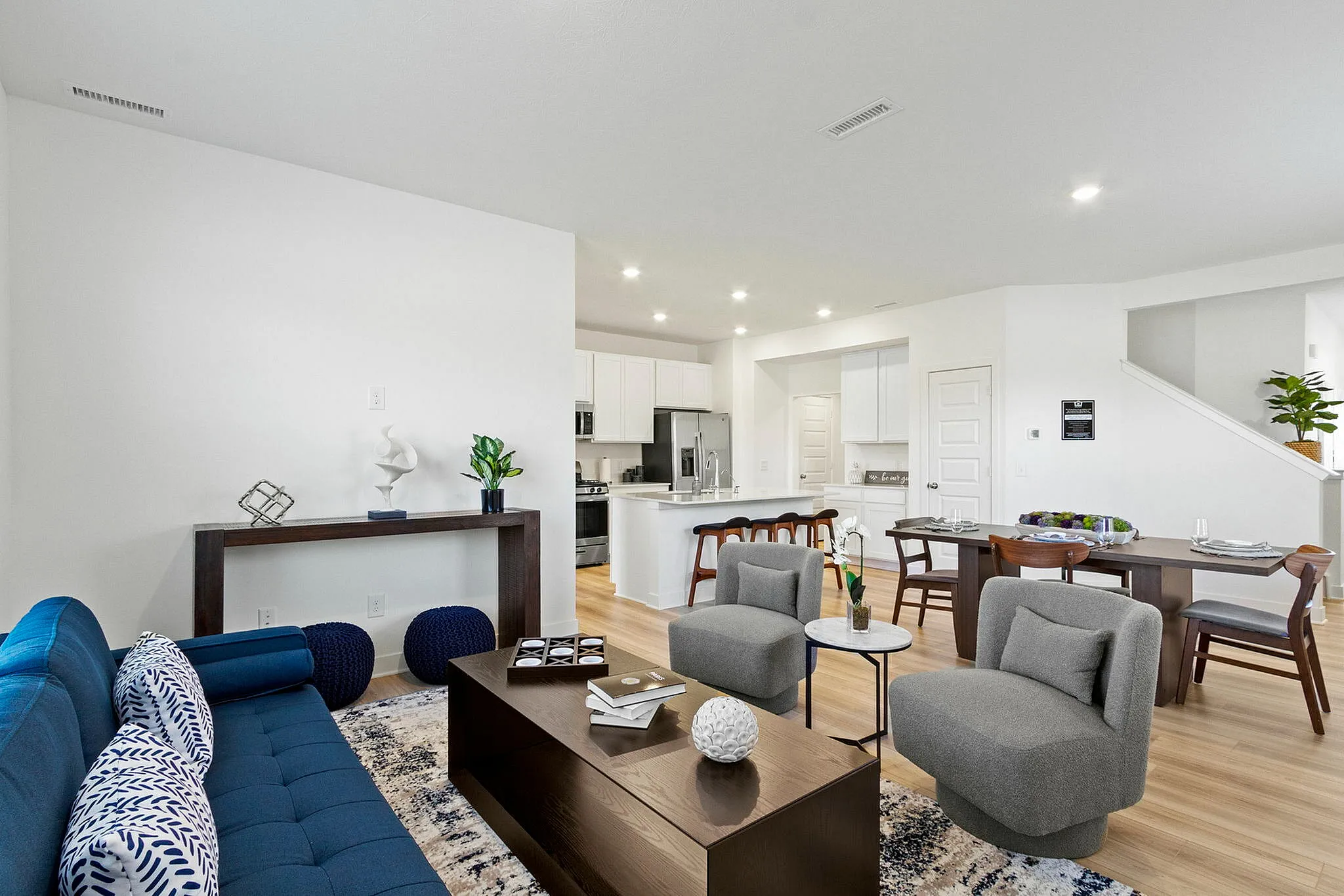 Furnished living area overlooking dining and kitchen area