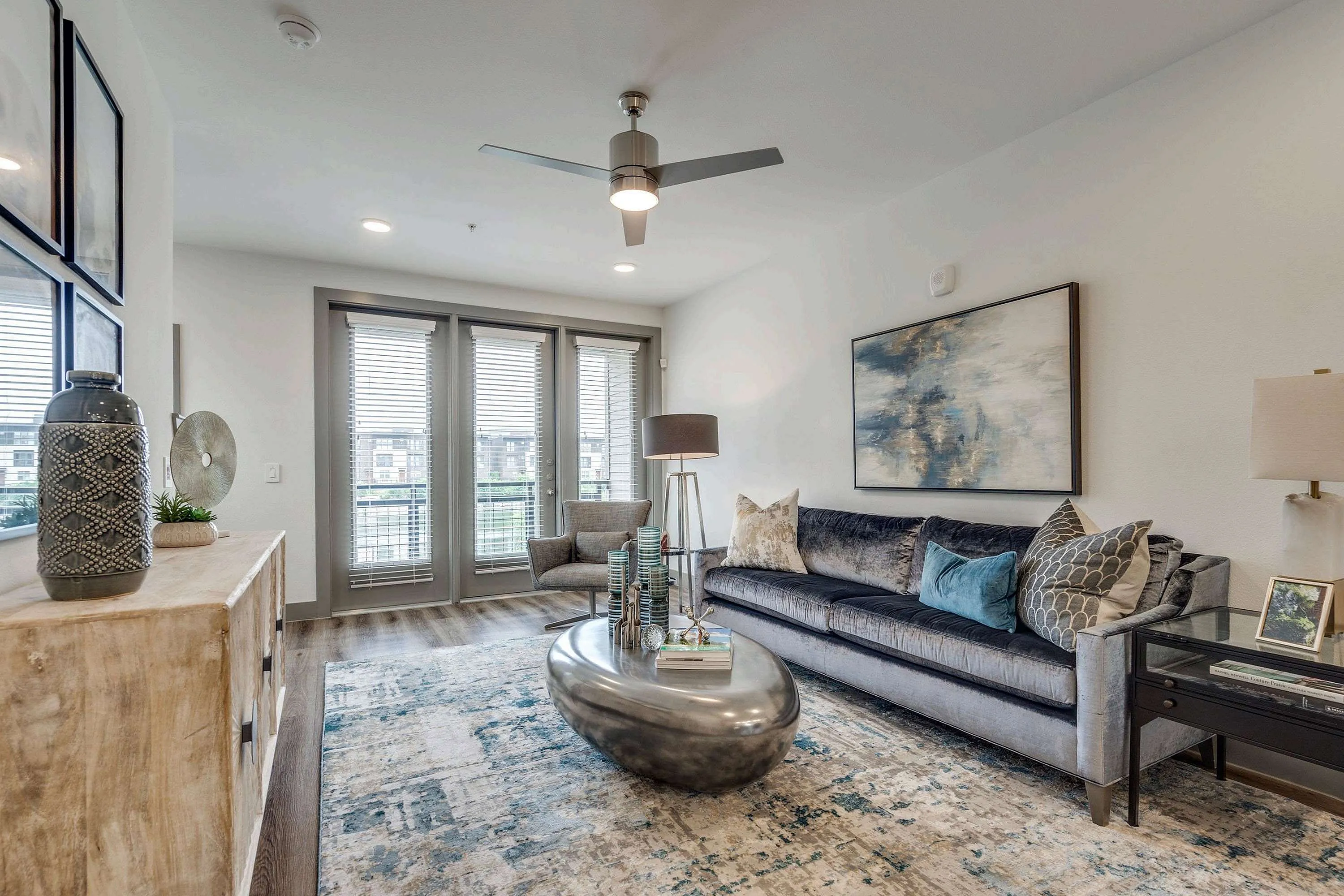 decorated and living area with windows and door leading to balcony