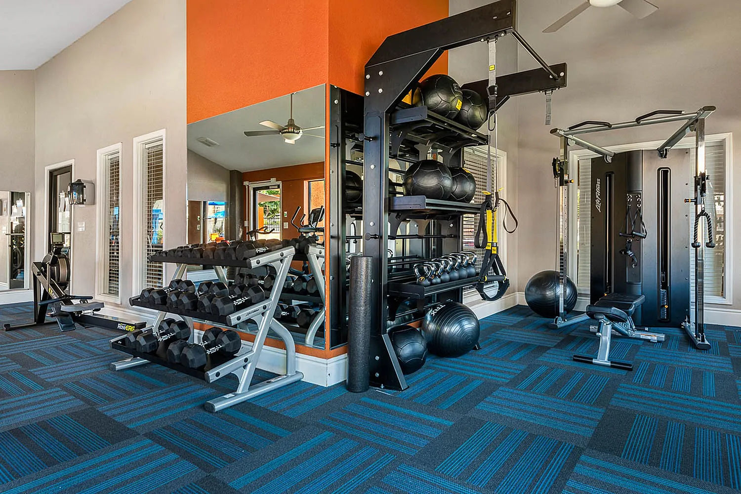 fitness center with free weights and equipment
