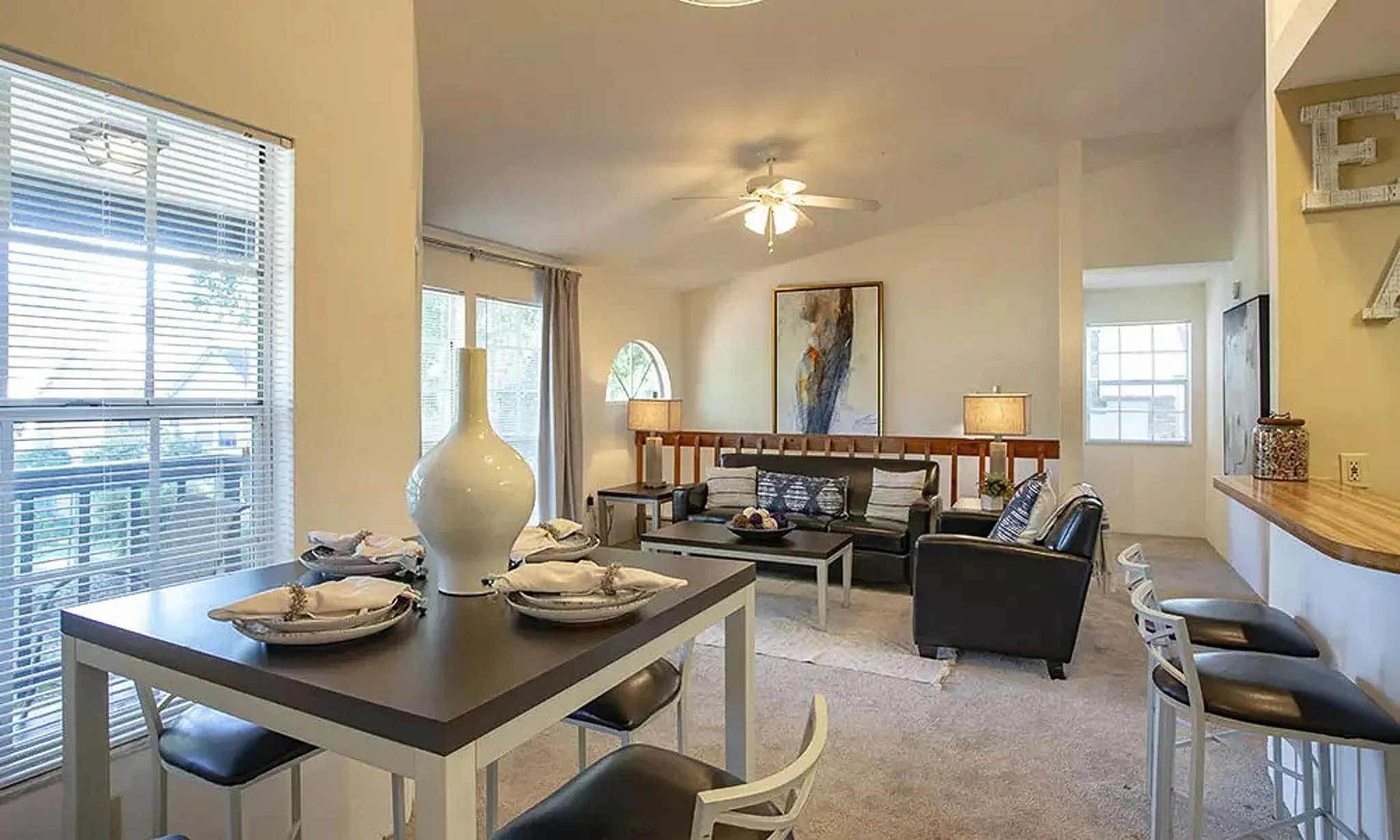 model home with dining table and couches