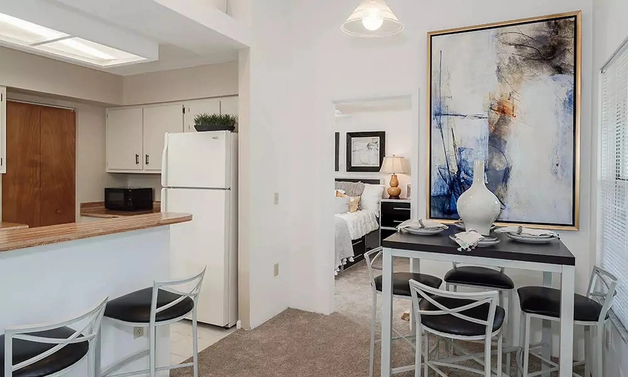 view of bedroom through kitchen with dining table