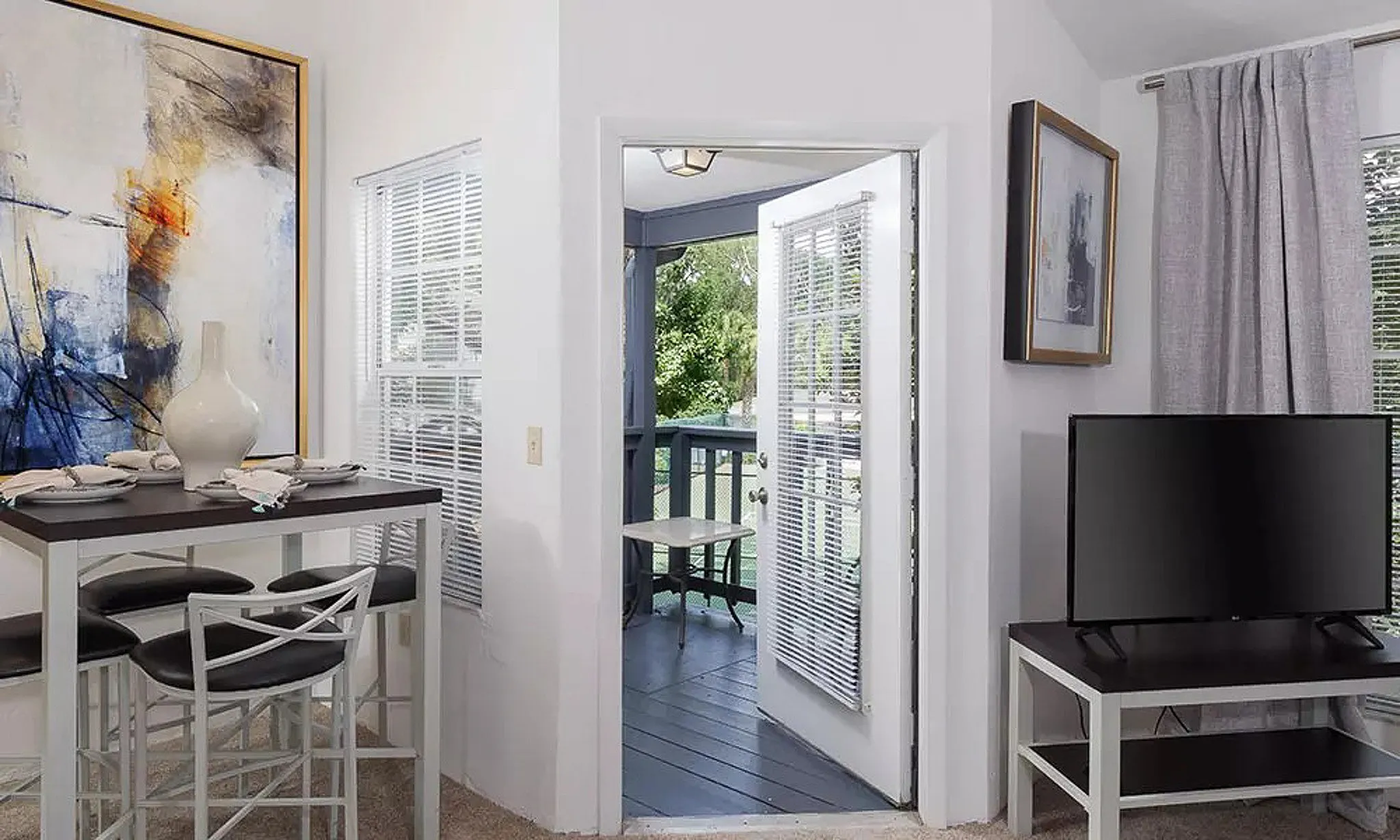 view of private patio/balcony with living room and dining table