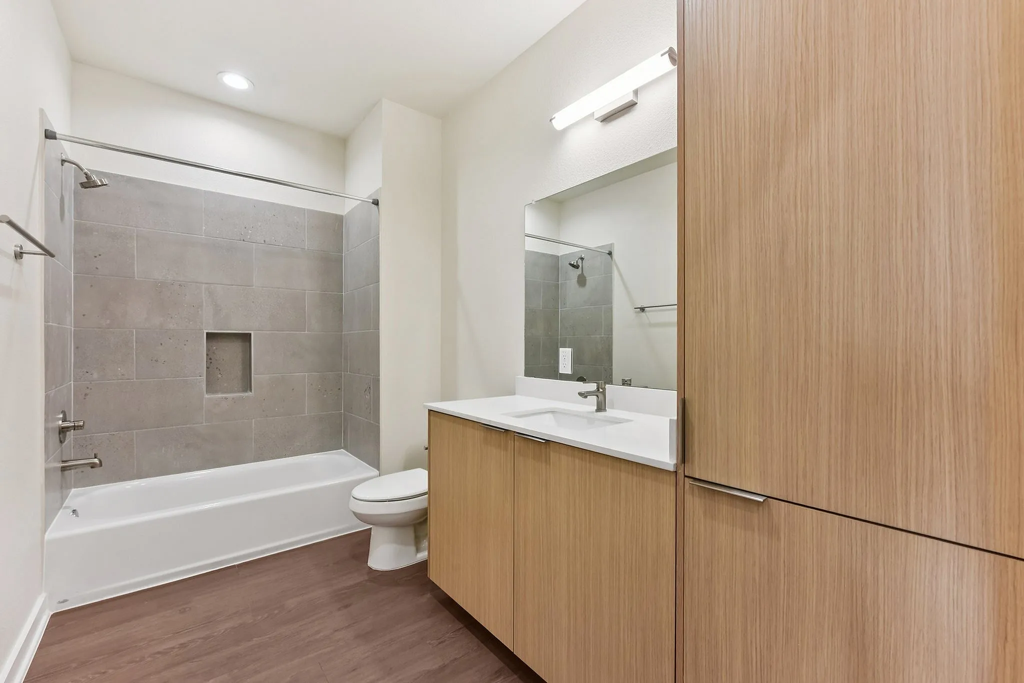 Bathroom with tub and large vanity with storage
