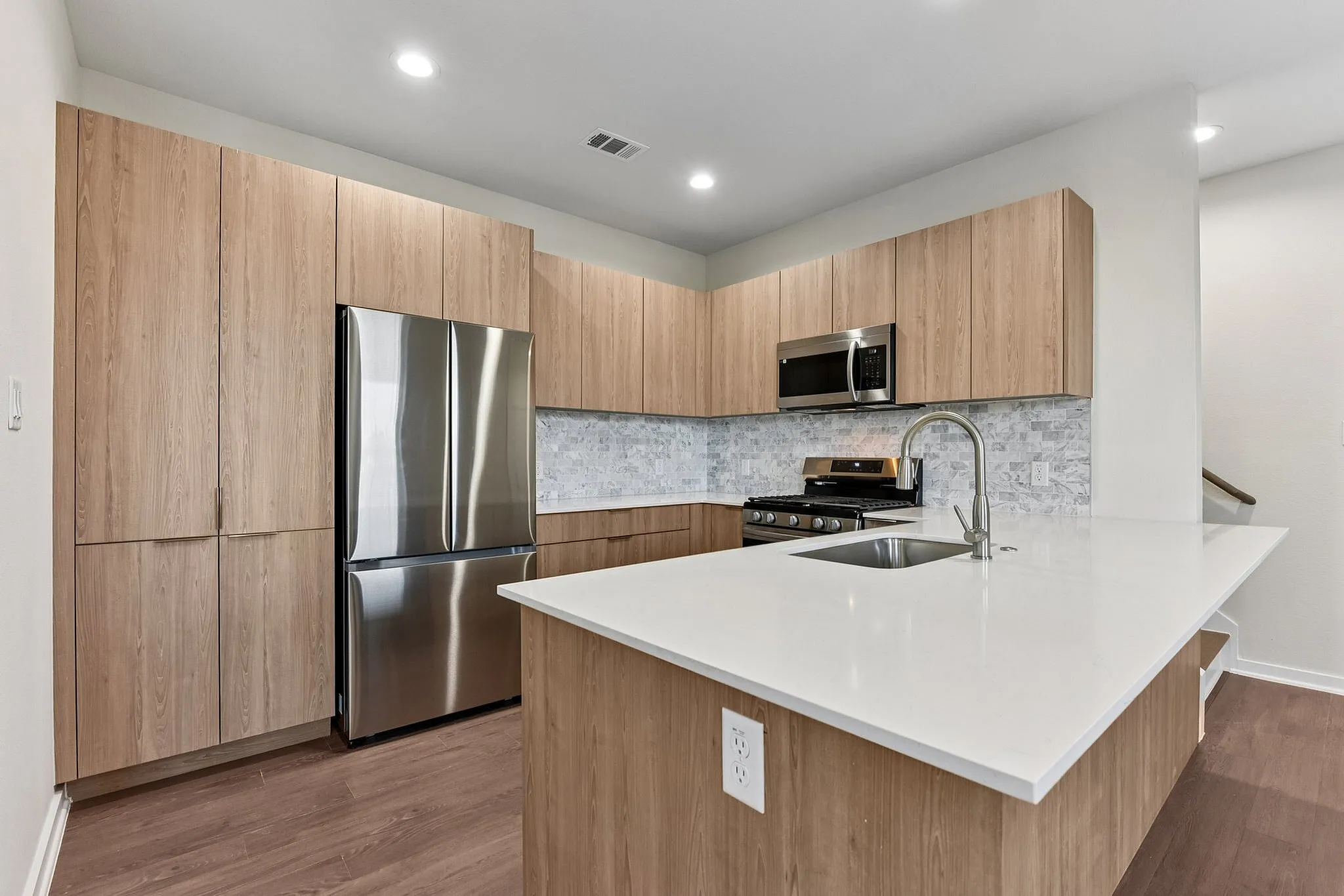Kitchen with light wood cabinets