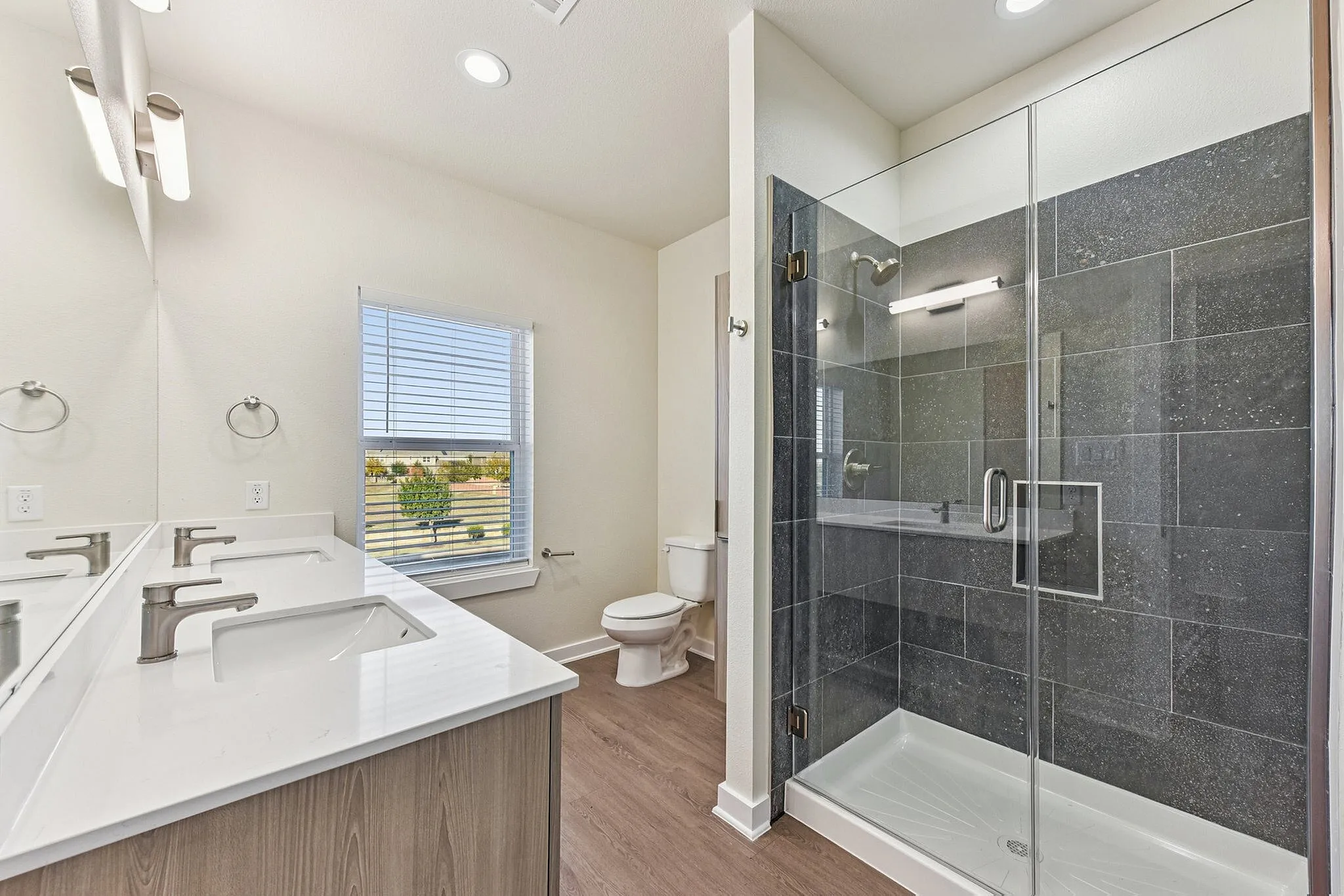 bathroom with double vanity, stand up shower