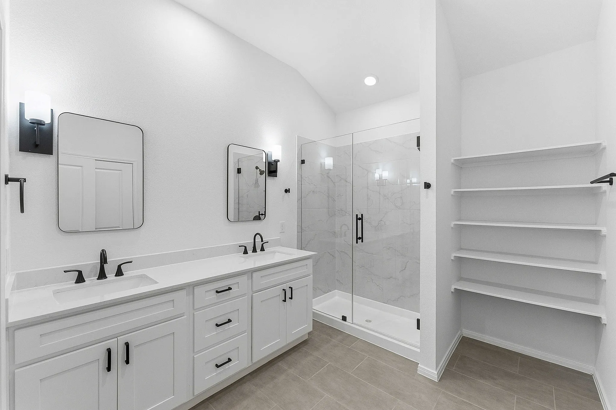 bathroom with black hardware and shelving with walkin shower