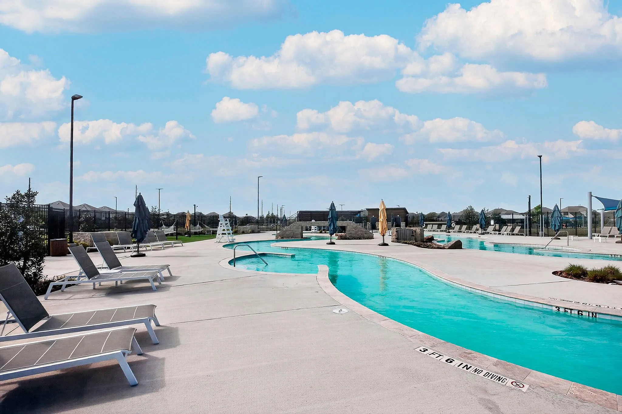 pool with lounge chairs and umbrellas